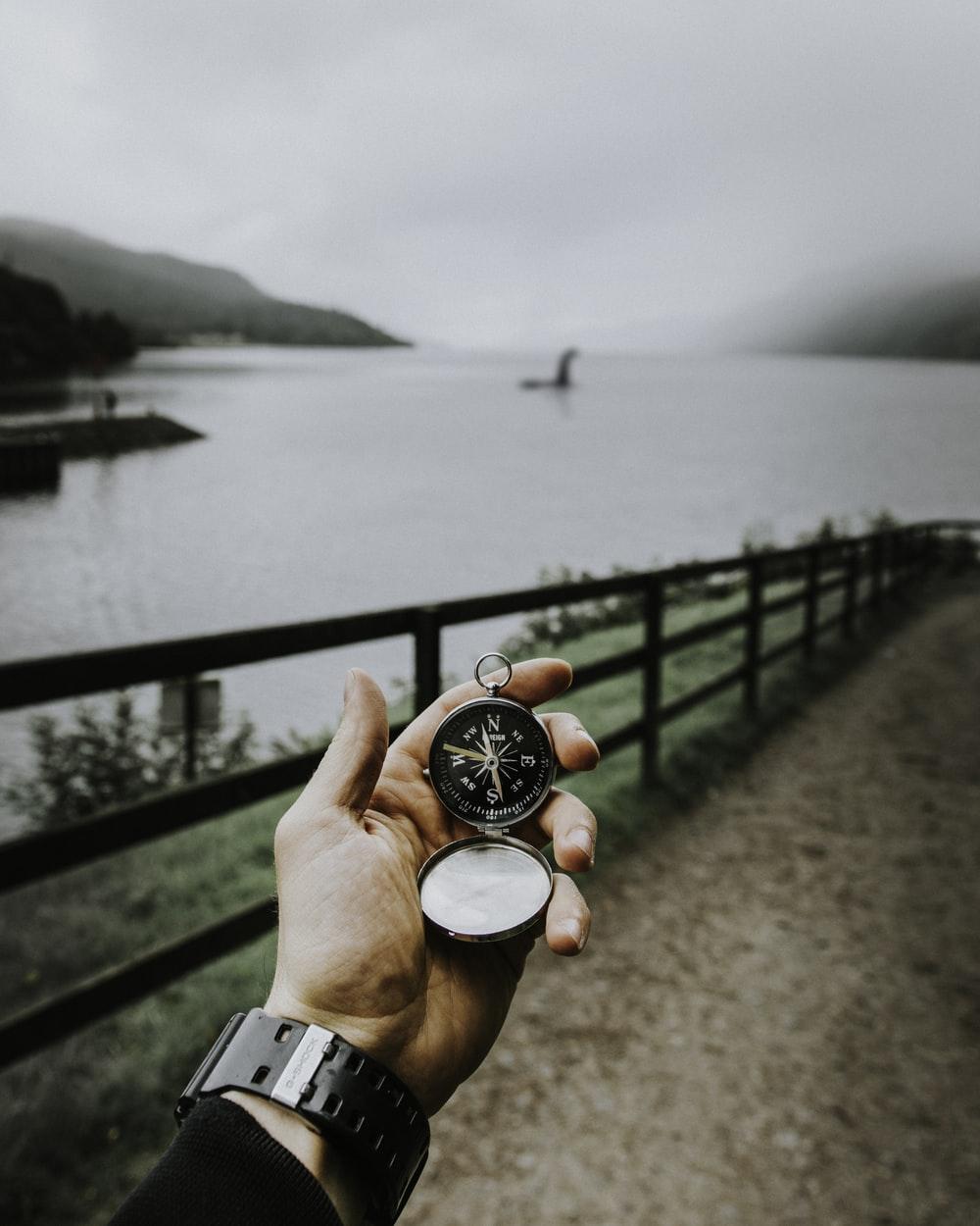 person using compass that leads to Loch Ness place photo