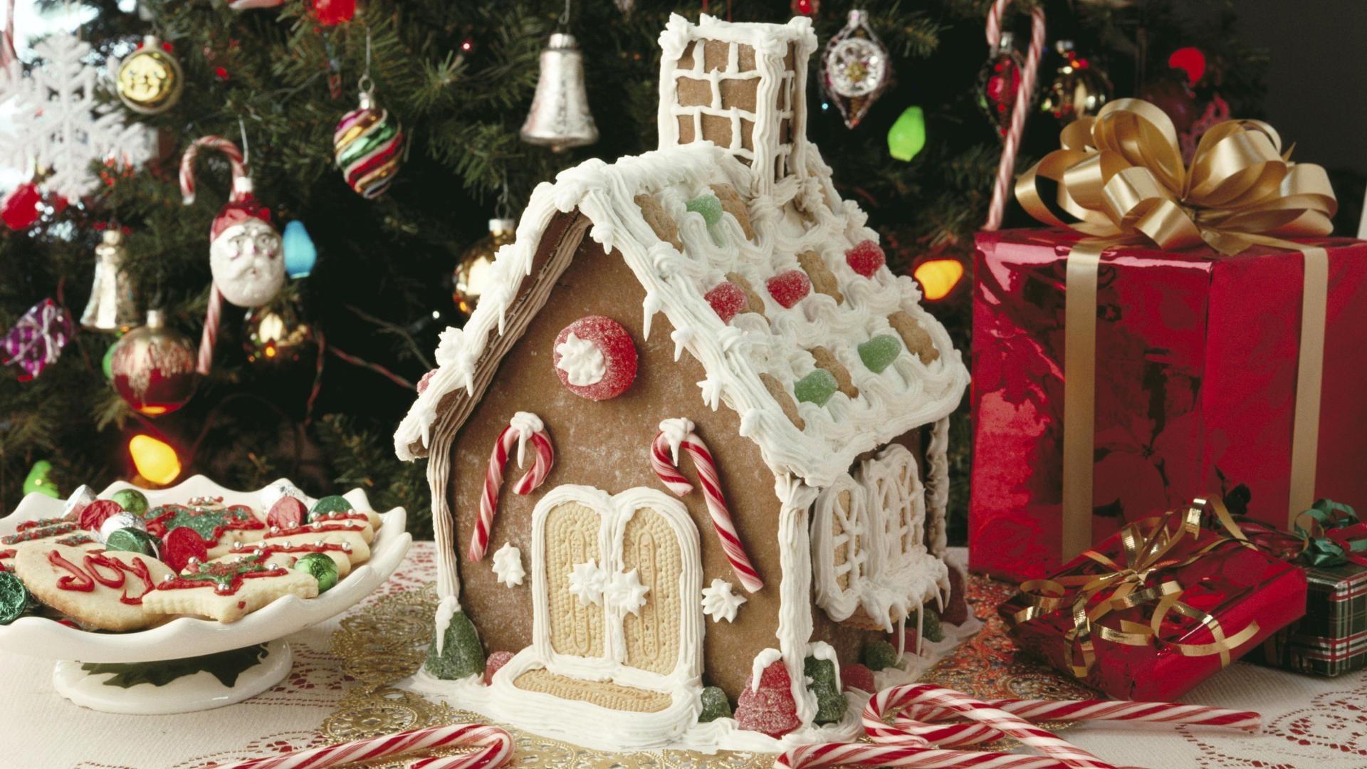 Gingerbread house beside footed bowl and red gift box HD