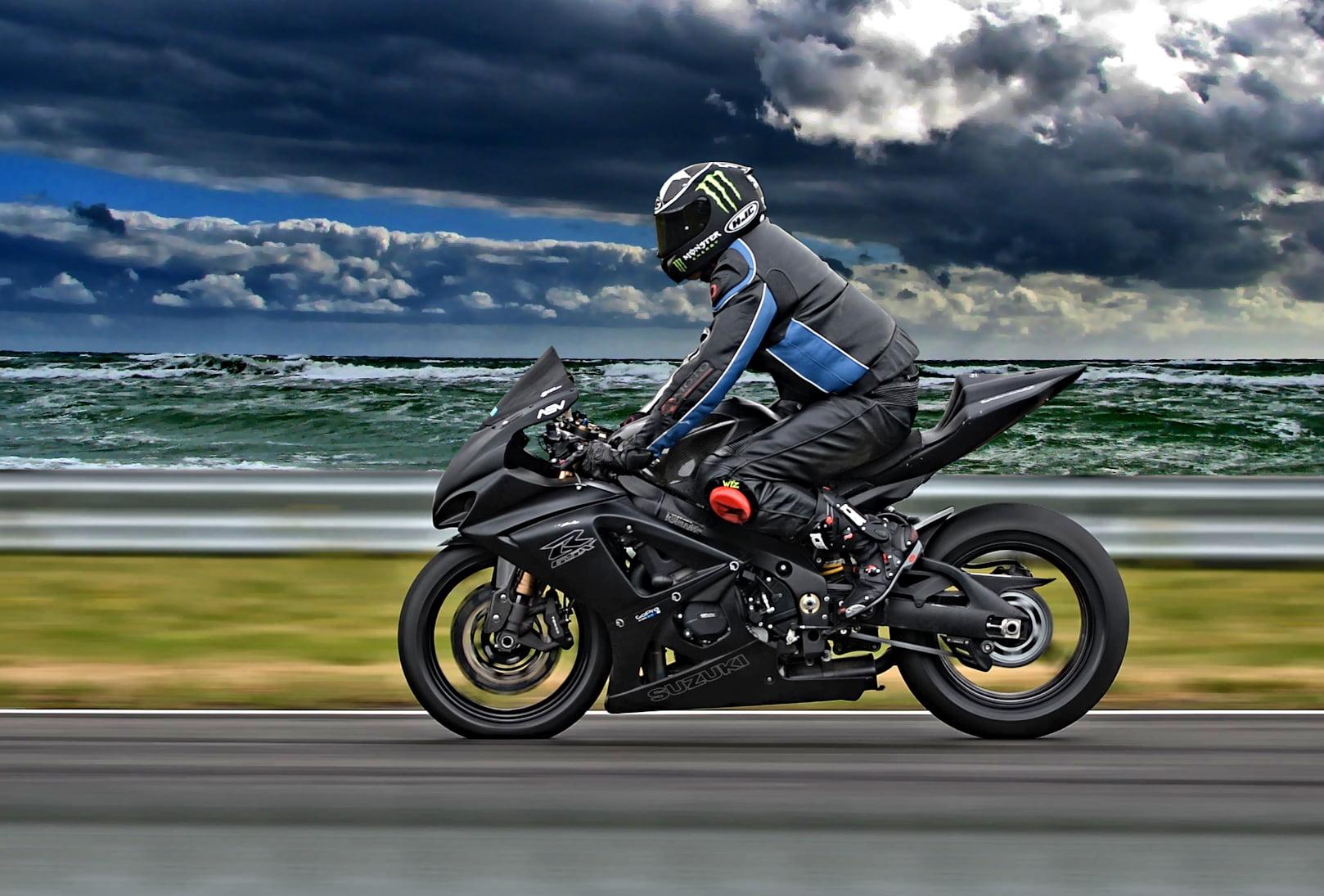 Man riding motorcycle on road near beach HD wallpaper