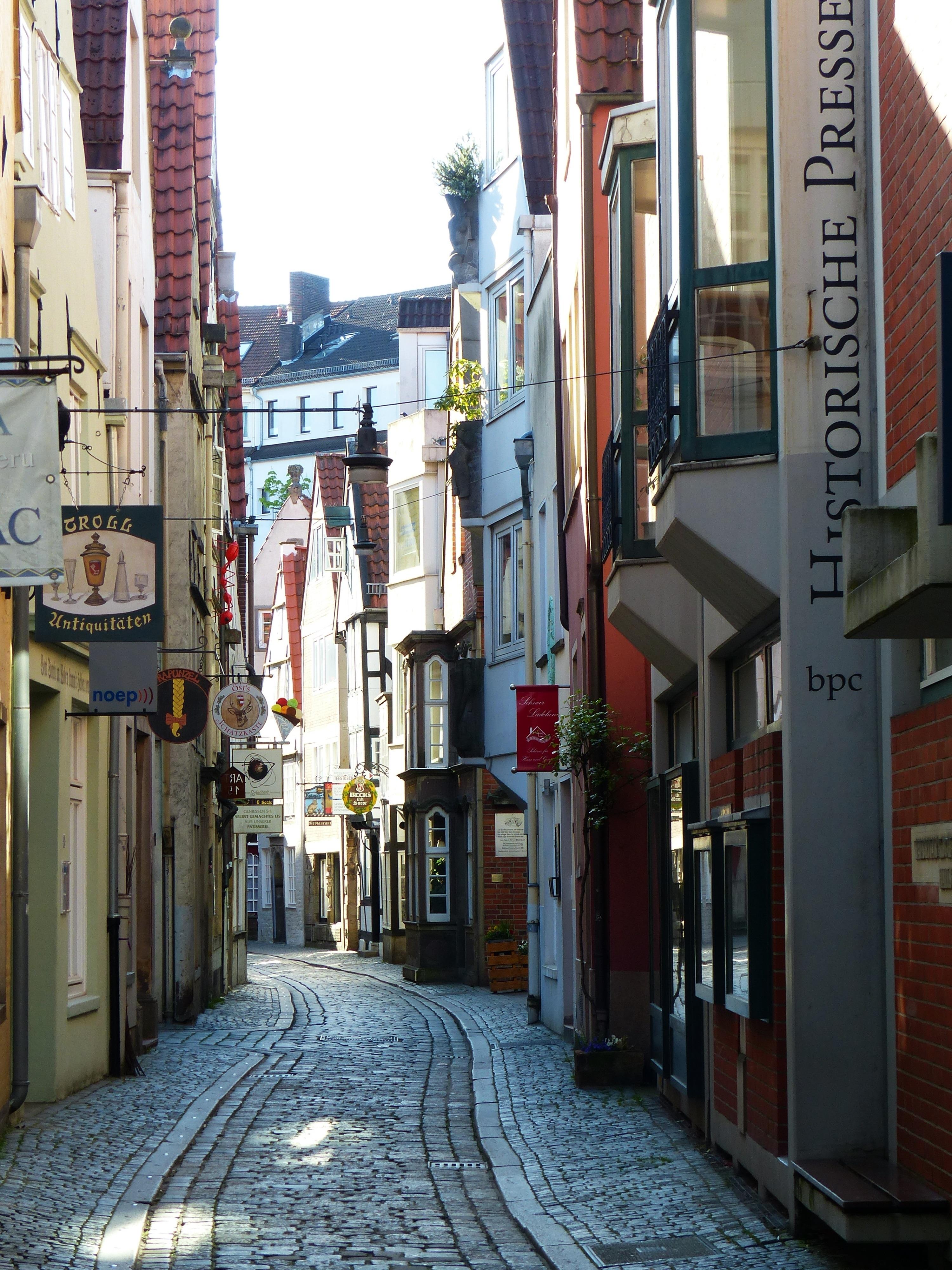 paved pathway between apartment buildings free image