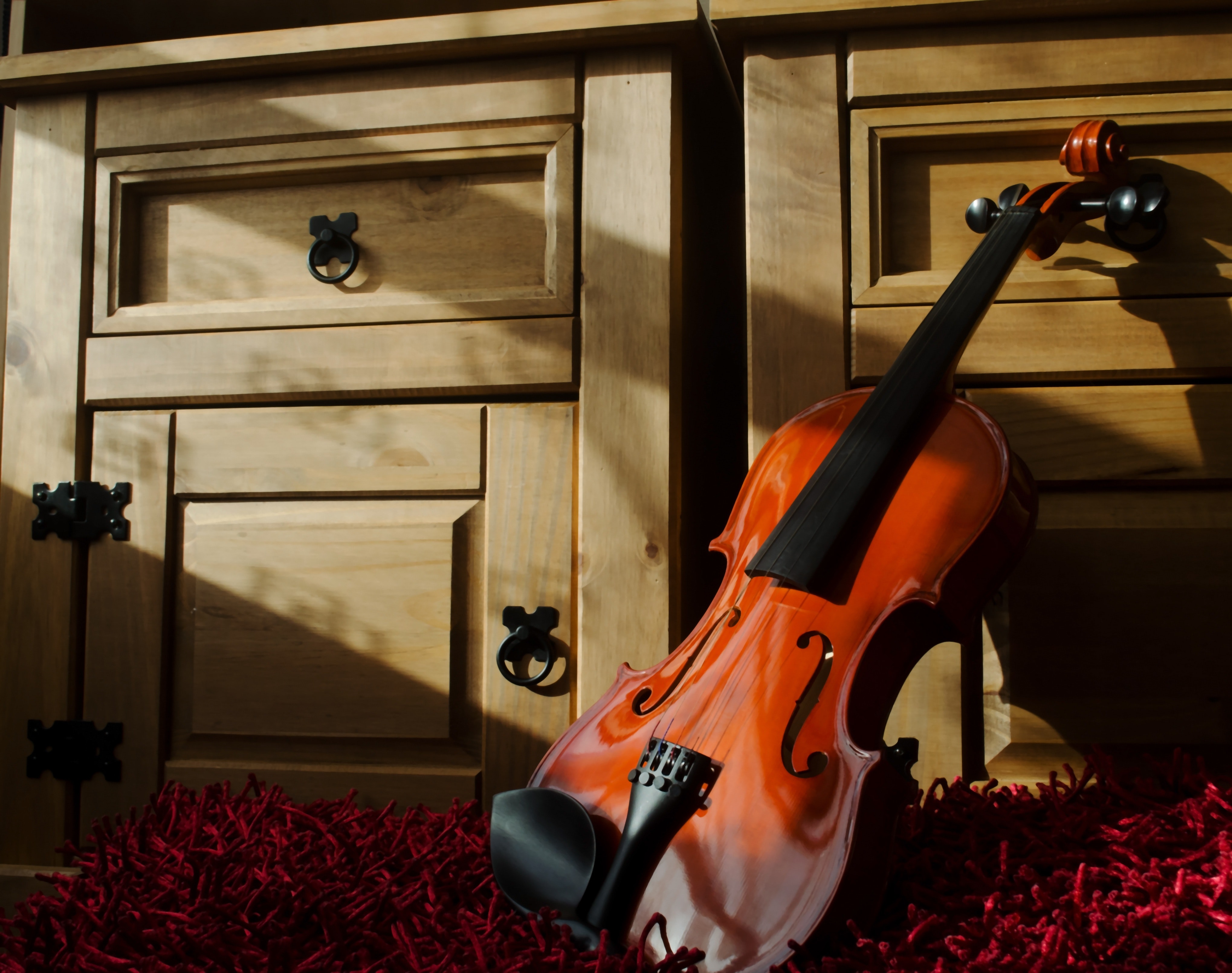 Brown Violin Leaning on Brown Wooden Cabinet · Free