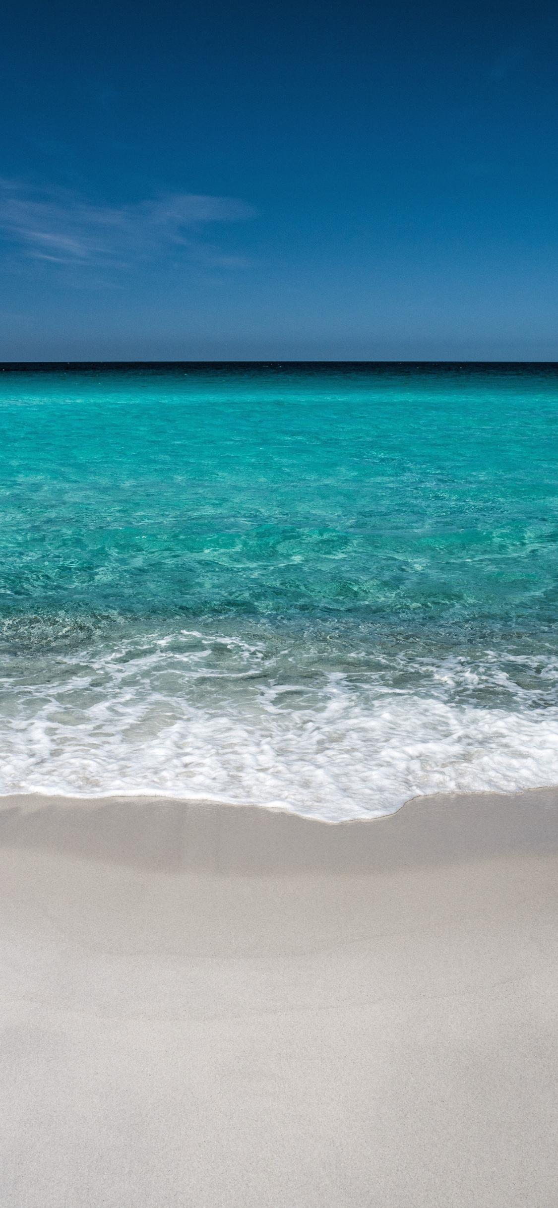Download 1125x2436 wallpaper beach, soft, sea waves, blue sea