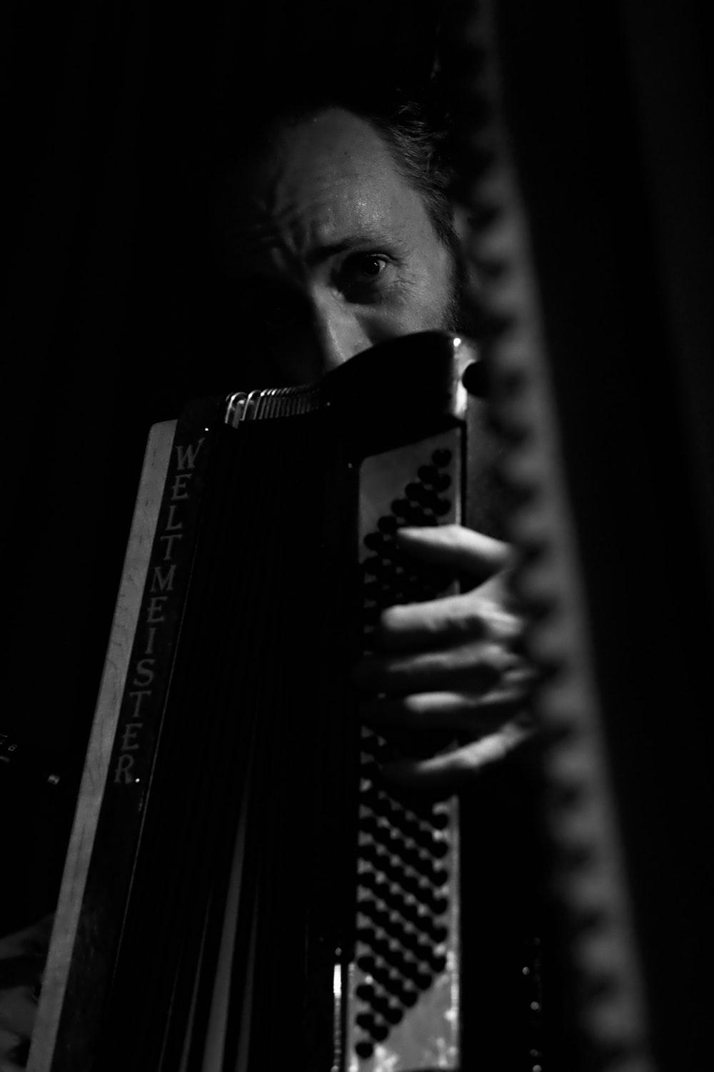 man holding harmonium photo