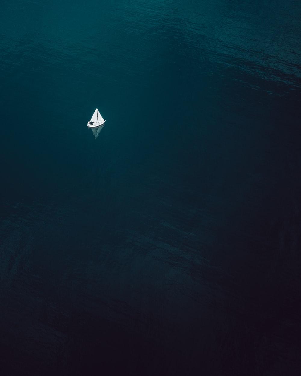 aerial photography of sailboat sailing on water body photo
