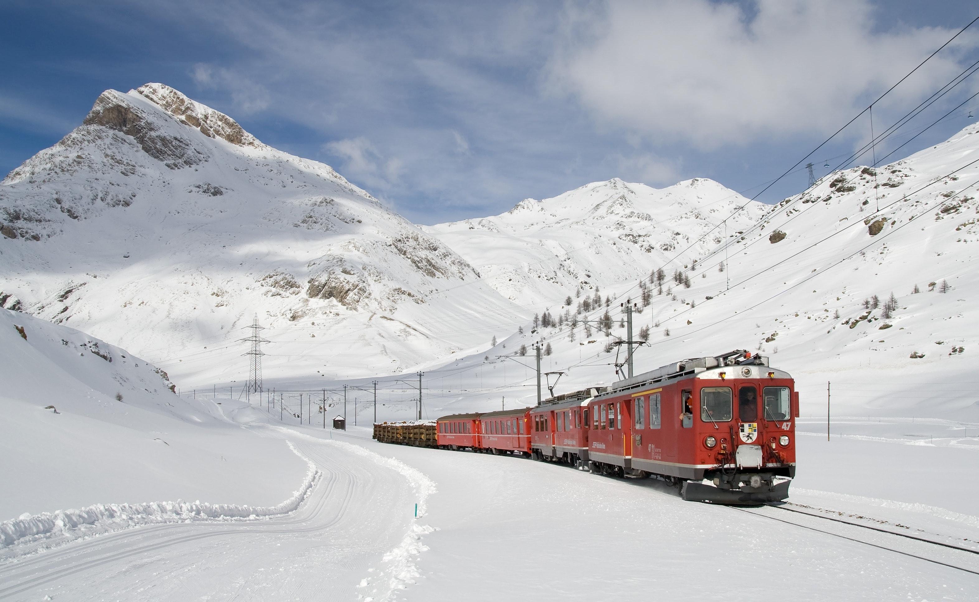 Red and Black Train Running Along Snow Covered Field · Free