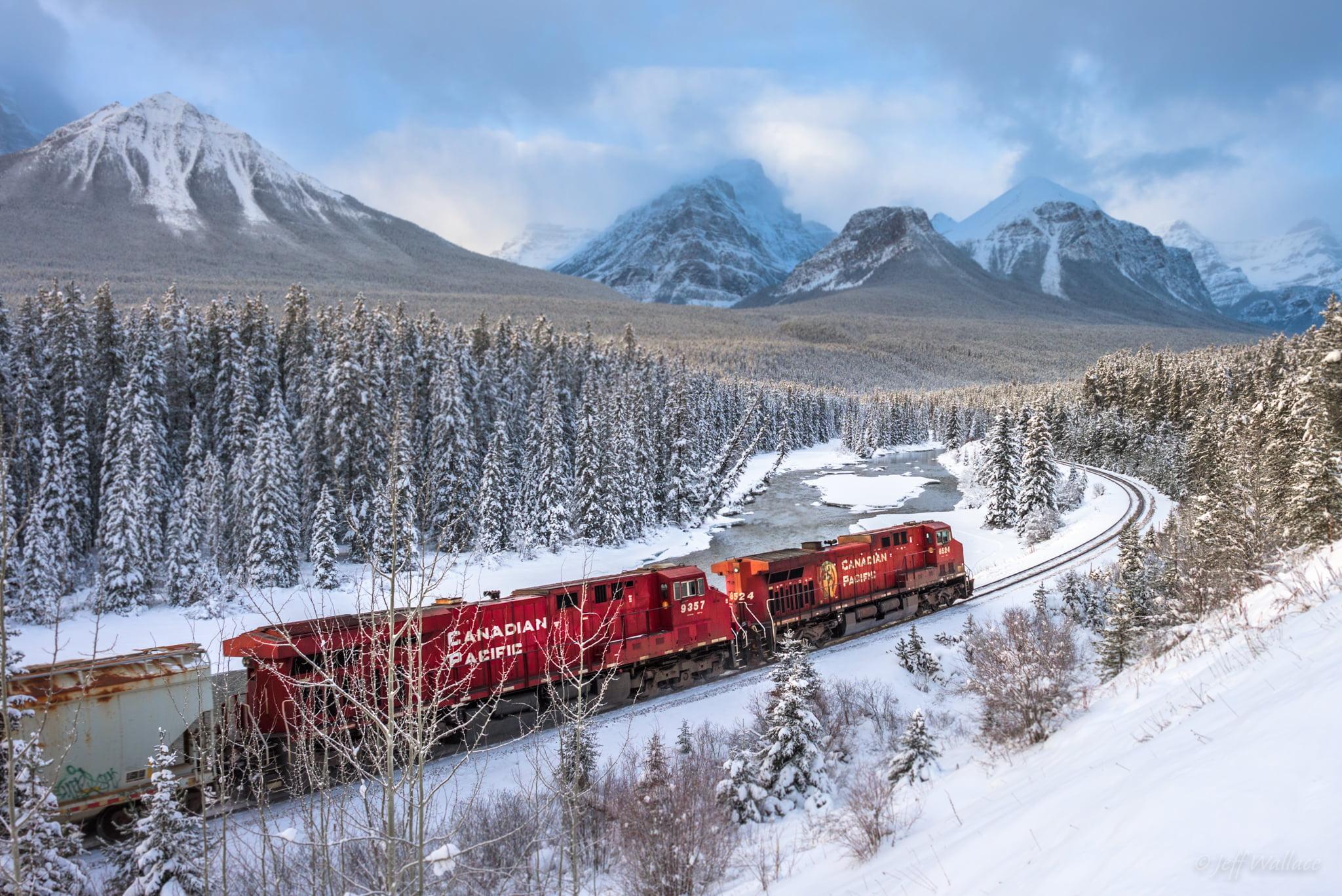 Photo Of Red Train Surrounded By Trees During Snow