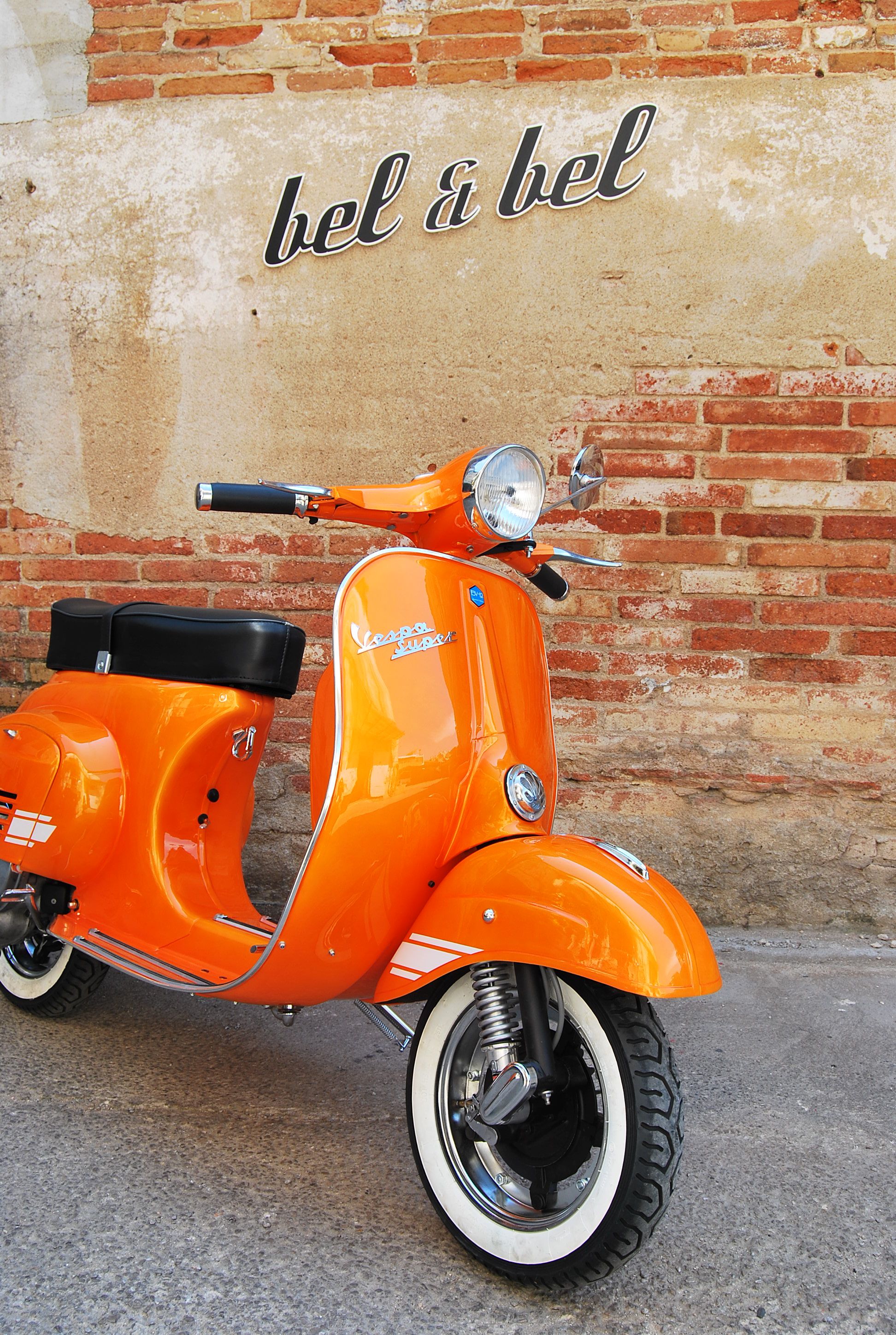 An orange Vespa! Love! I also adore the font of thebel