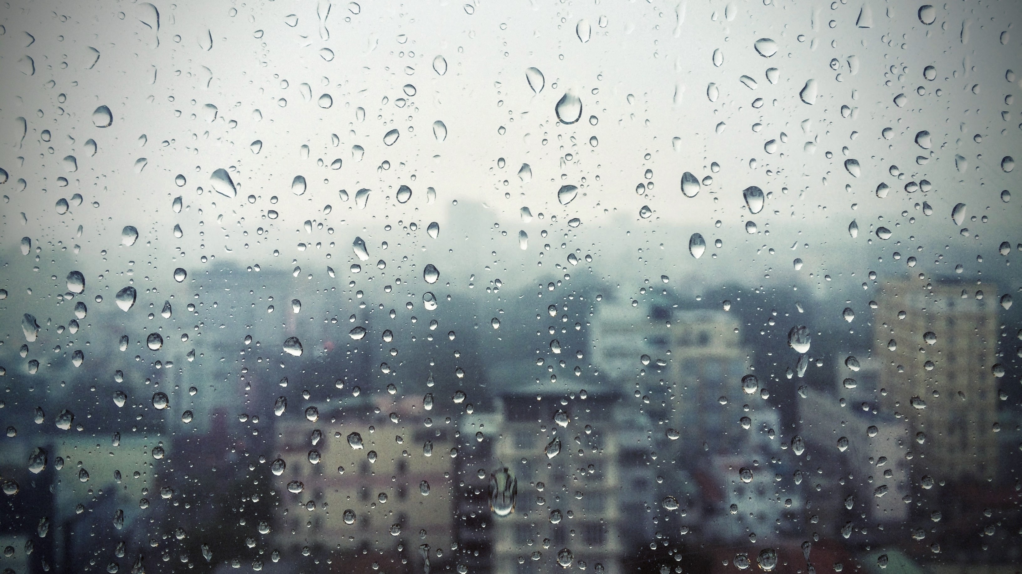 Download wallpaper 3264x1835 rain, window, glass, buildings