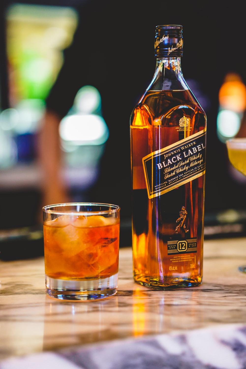 Whiskey glass with splash, isolated on black background Stock Photo | Adobe  Stock
