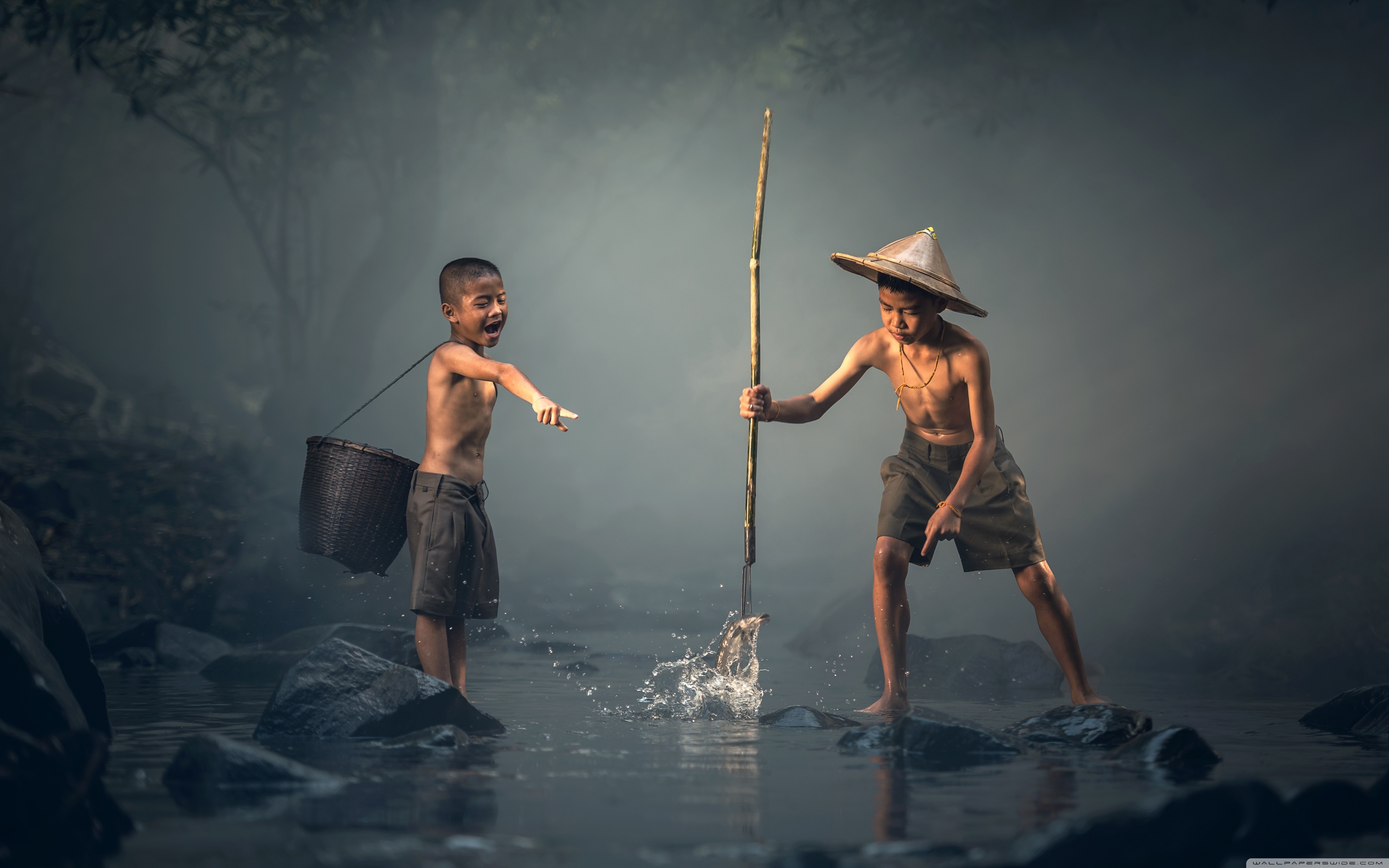 Boy Catching Fish with a Spear Ultra HD Desktop Background