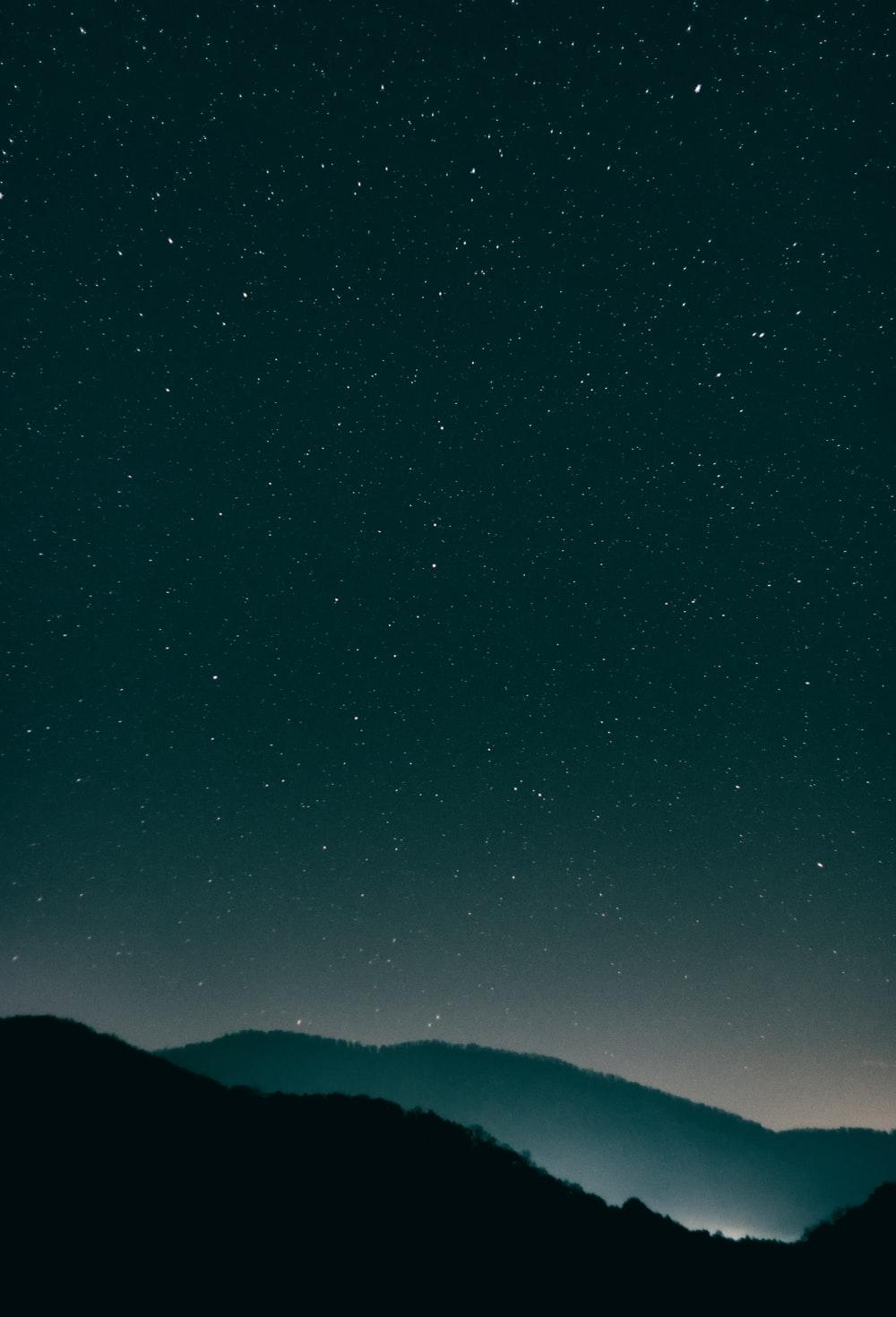 mountains under starry night photo