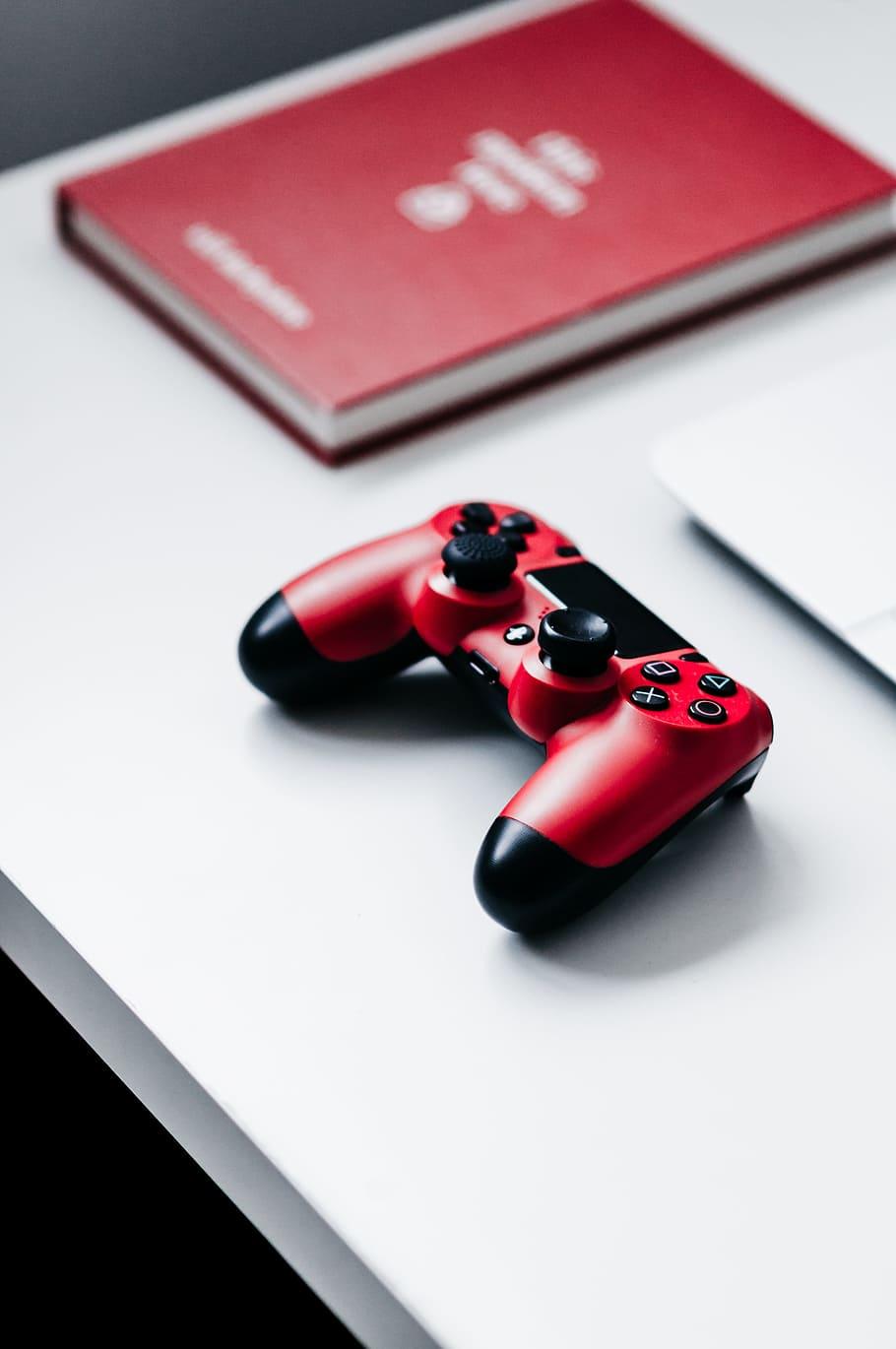 HD wallpaper: playstation gaming, desk, book, red