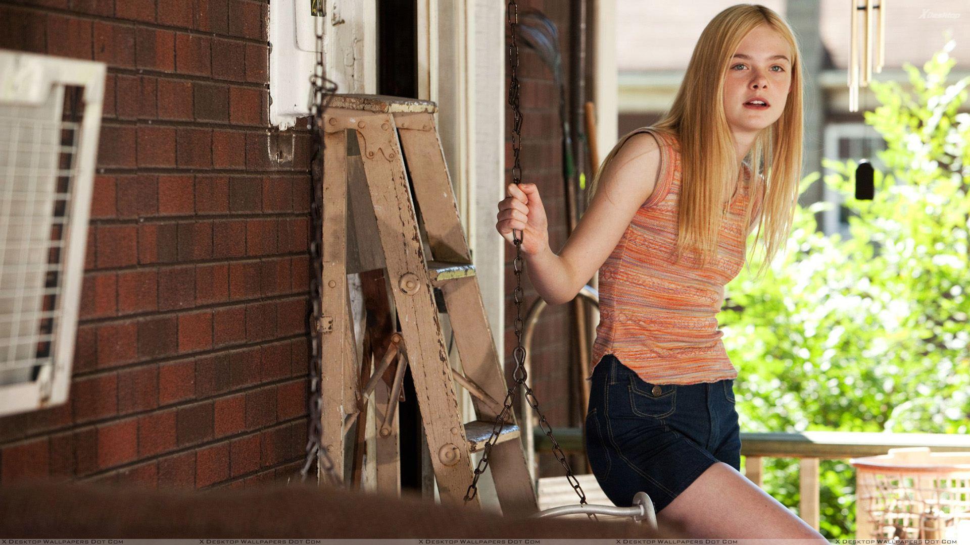 Elle Fanning Outside House In Orange Top Wallpaper