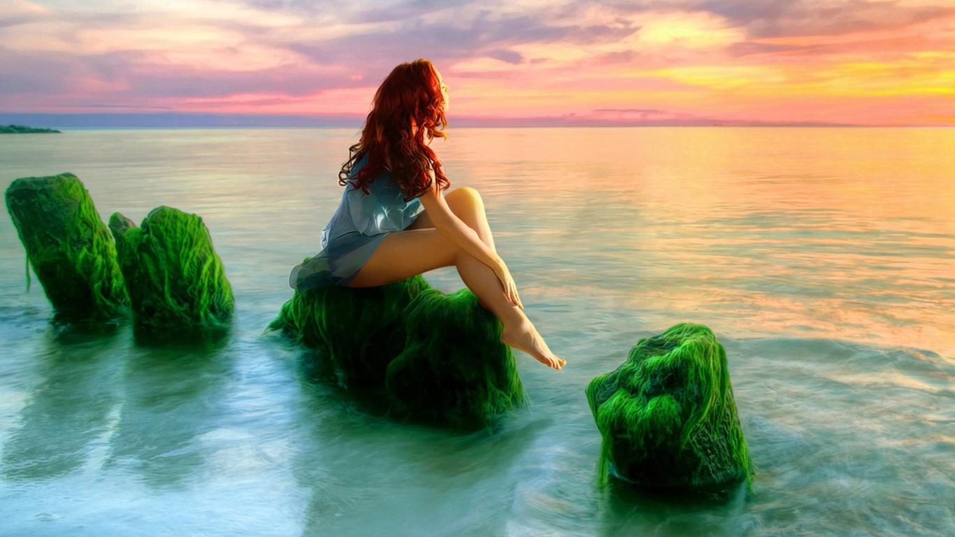 Mermaid on the green rocks watching the sunset Desktop