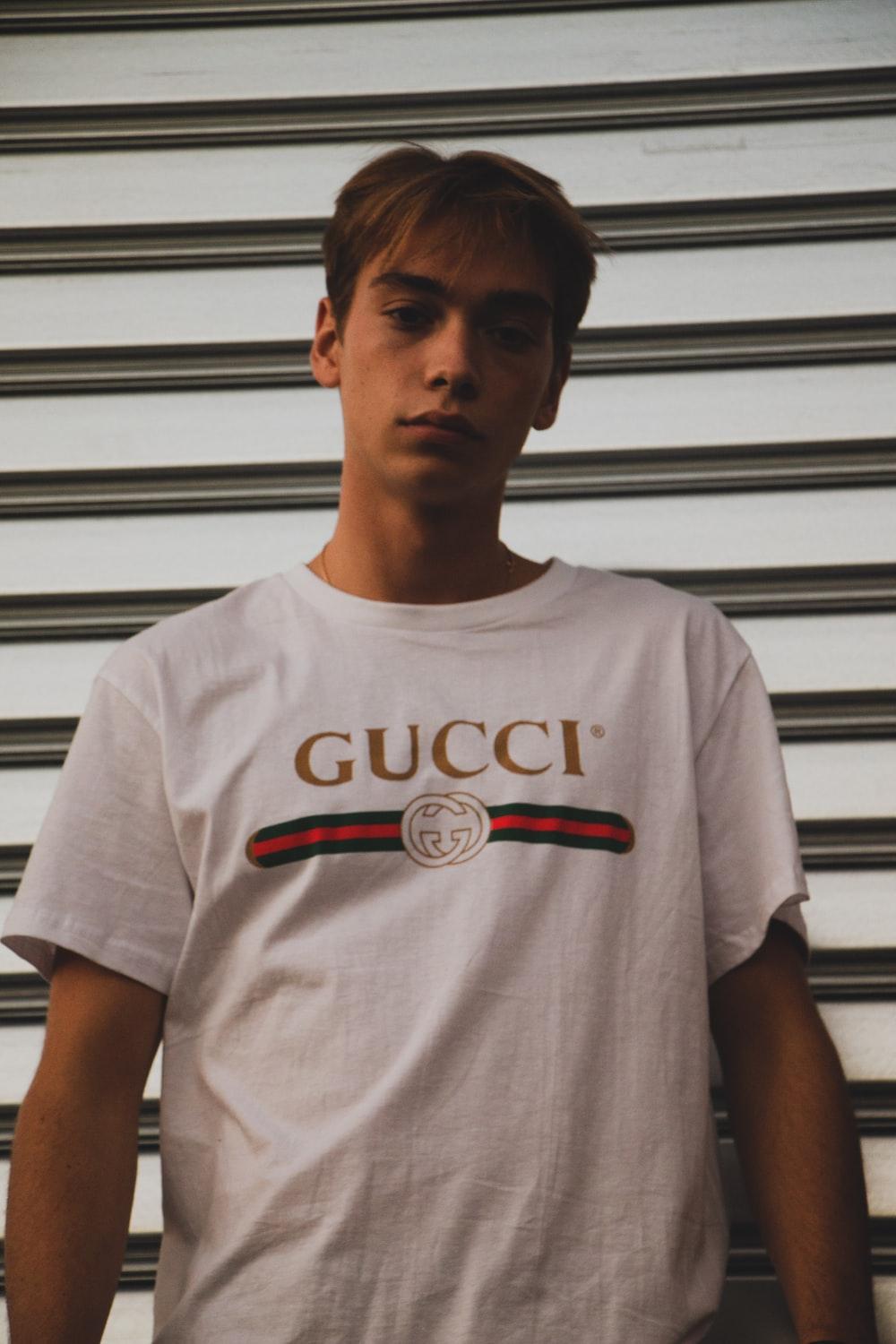man wearing white Gucci shirt photo