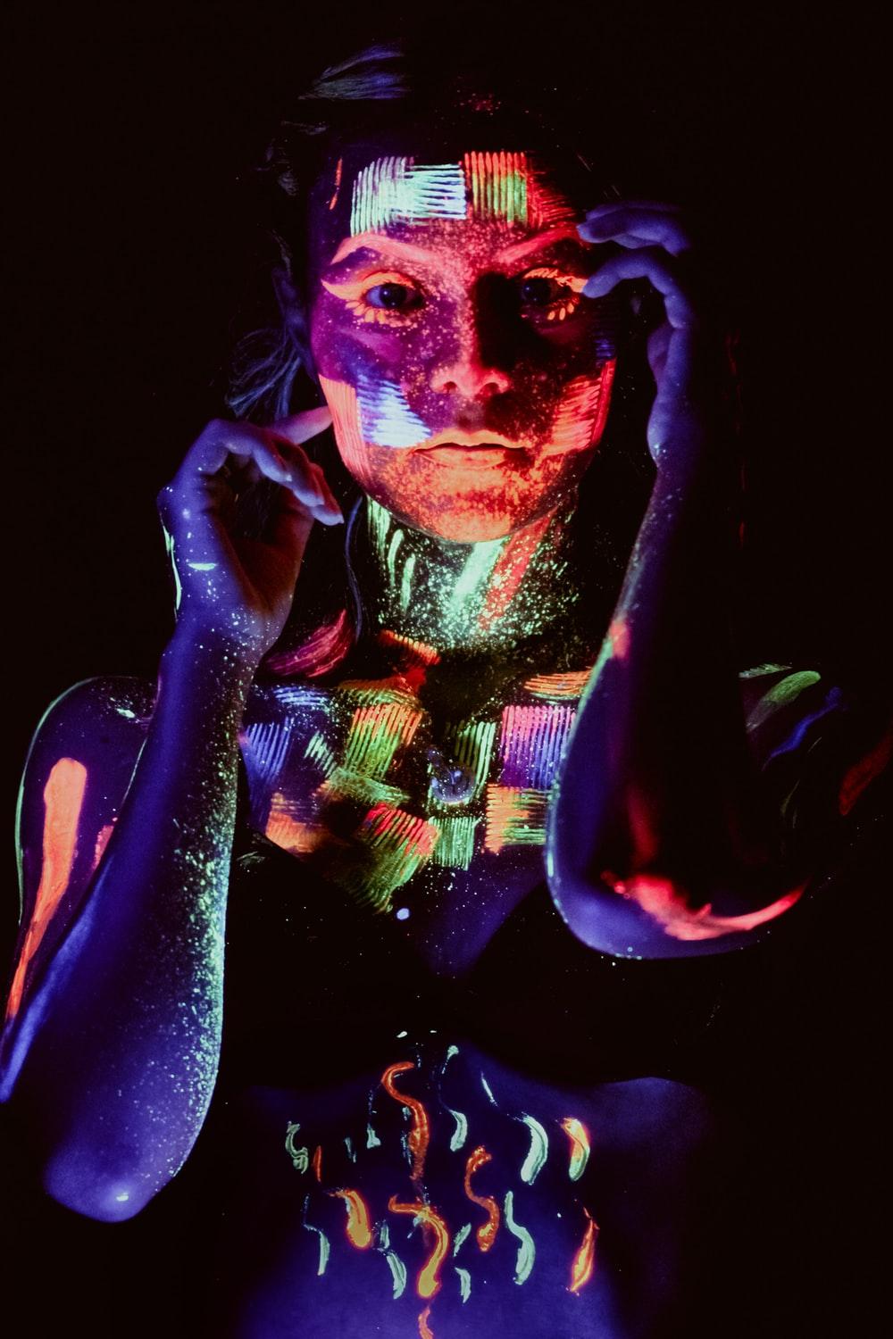 woman with neon paint on face photo