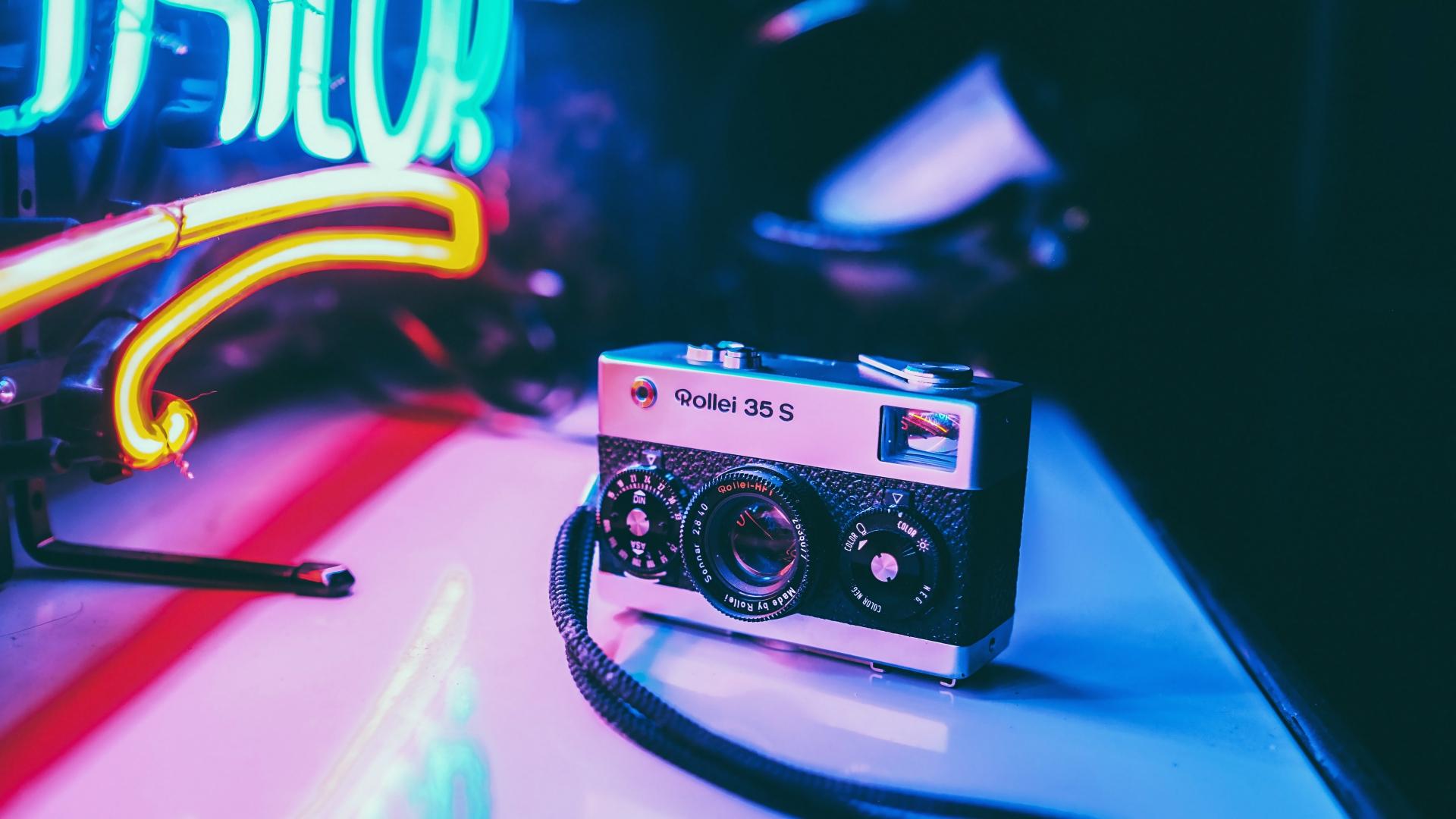 Vintage camera Rollei 35s with neon lights Wallpaper 4k