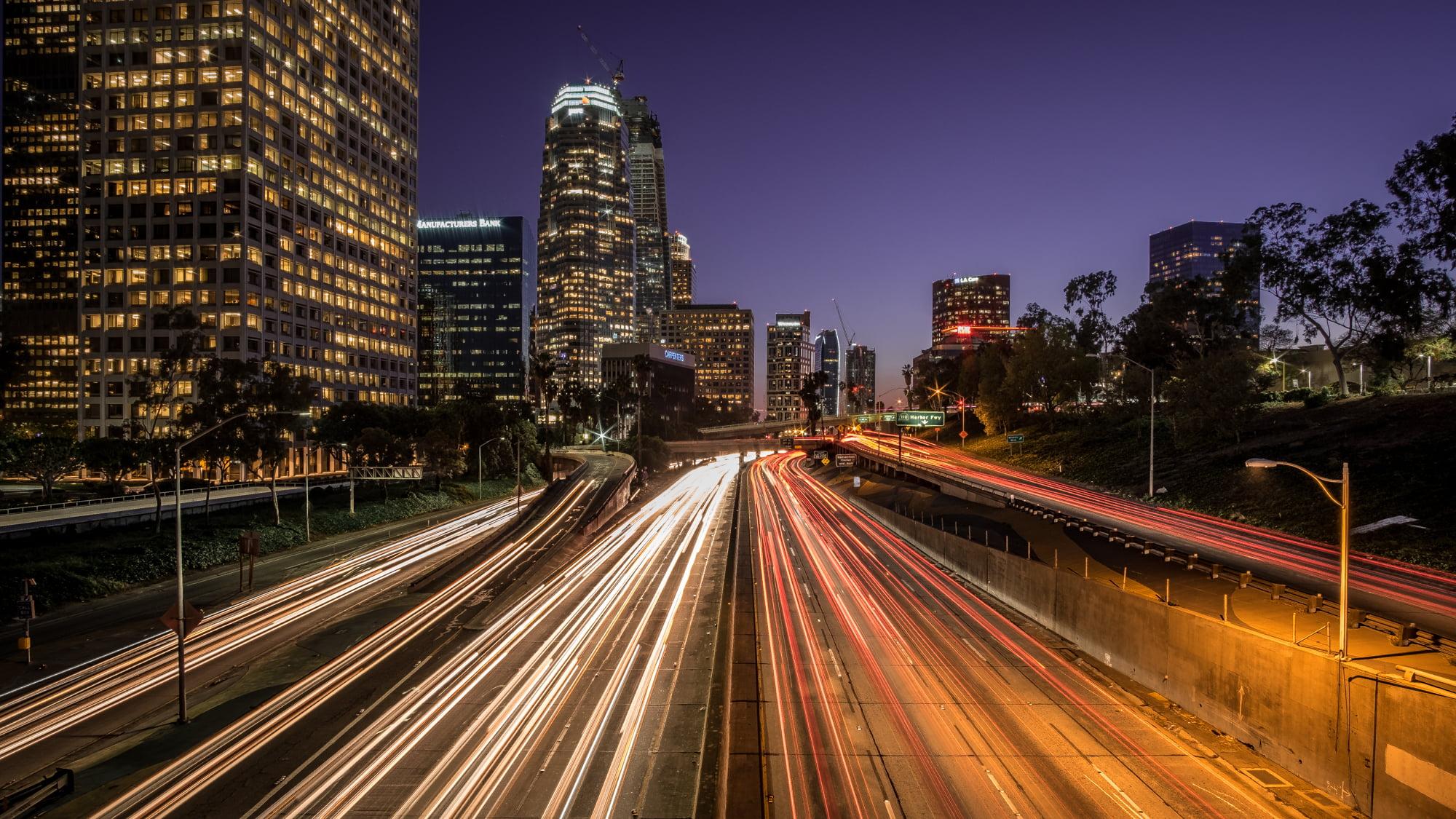 View of buildings with road during night time, highway 110