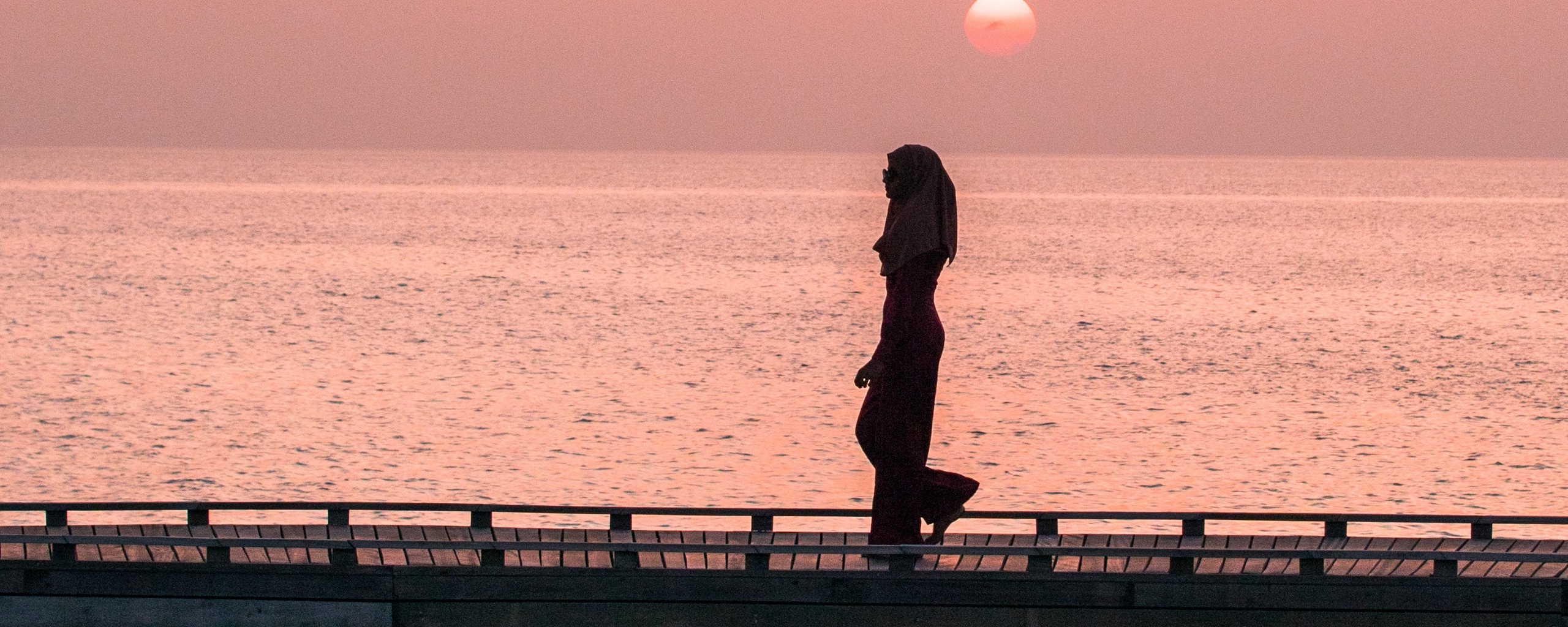Download wallpaper 2560x1024 girl, bridge, water, dusk, sunset