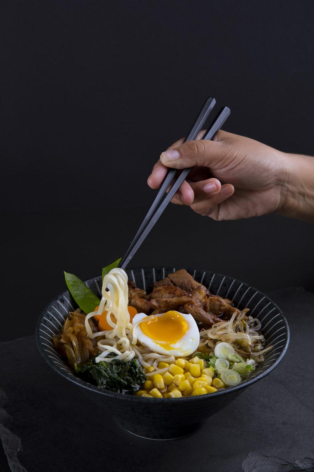 macro photography of ramen served in black bowl photo