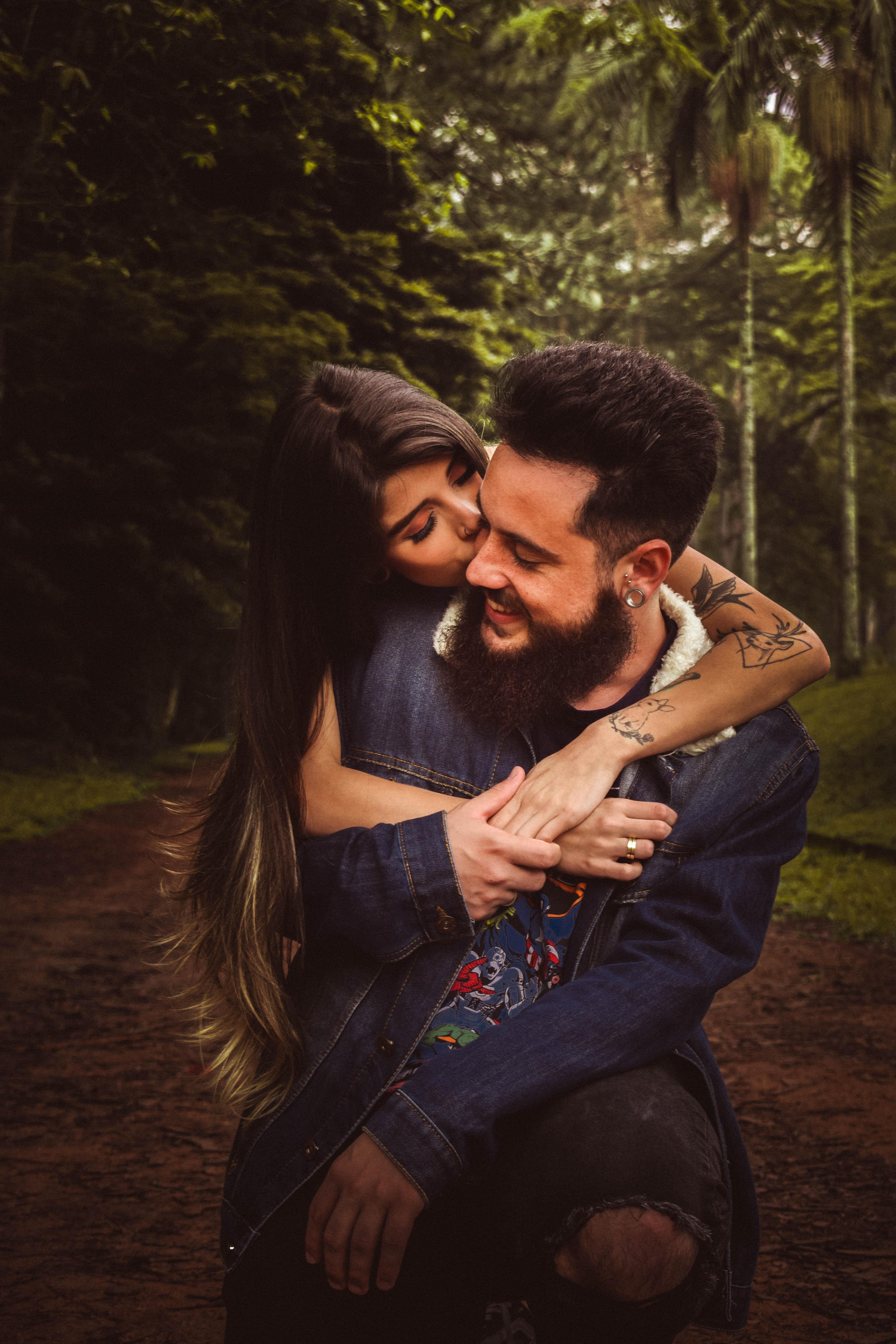 Woman Back Hugging and Kissing Man in Forest · Free