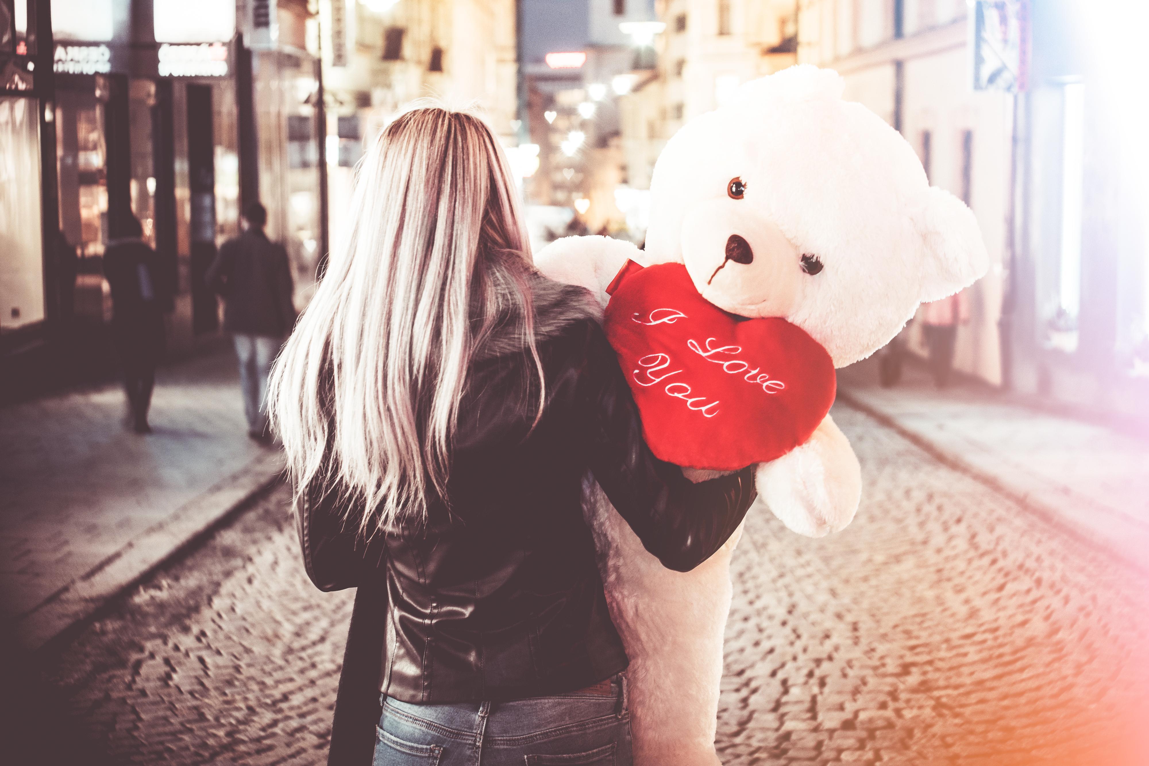 Young Woman Holding Her Big Valentine's Day Gift Teddy Bear Free