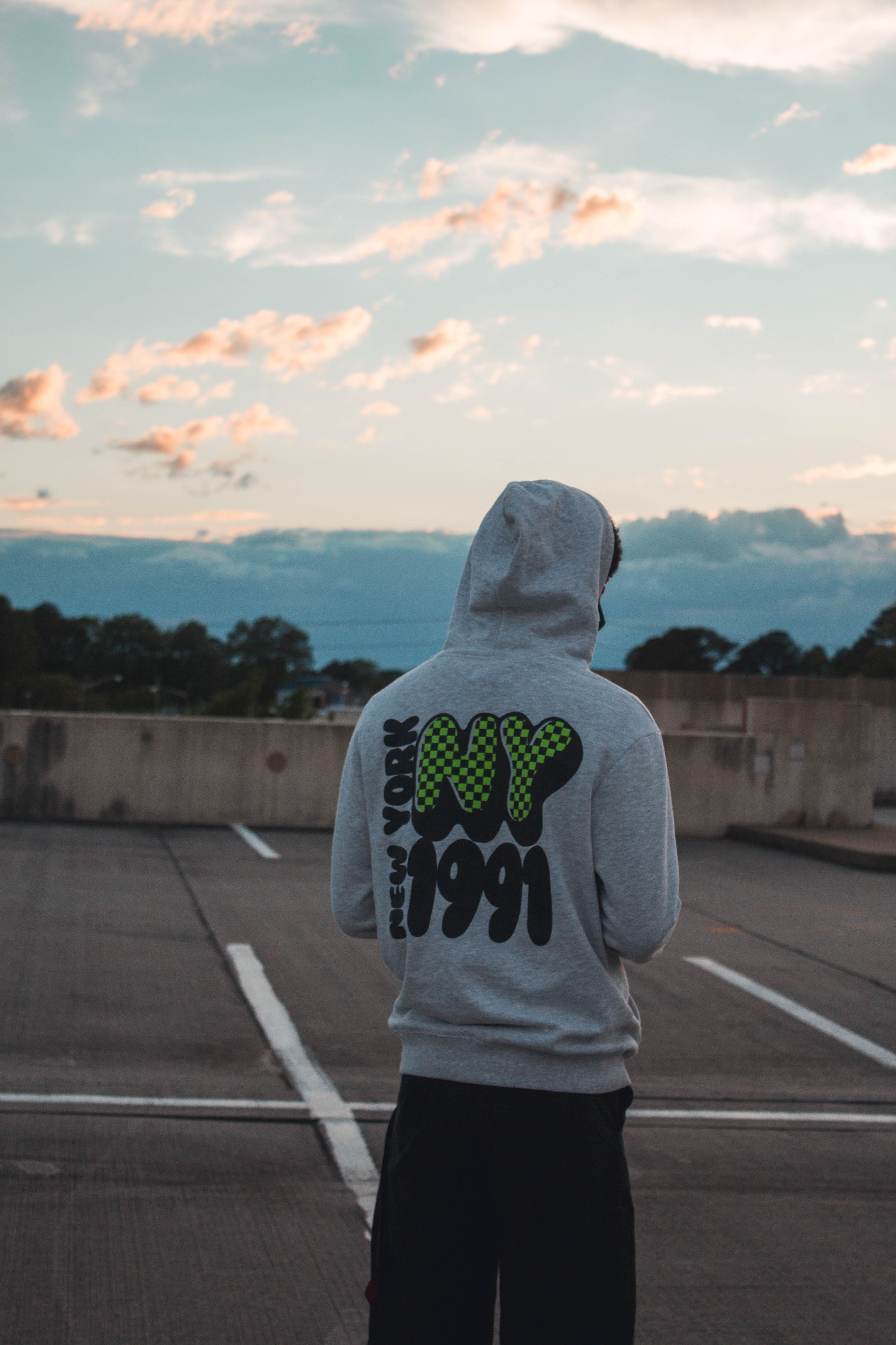 Rear view of Man Wearing Gray Pullover Hoodie and Black Pants at