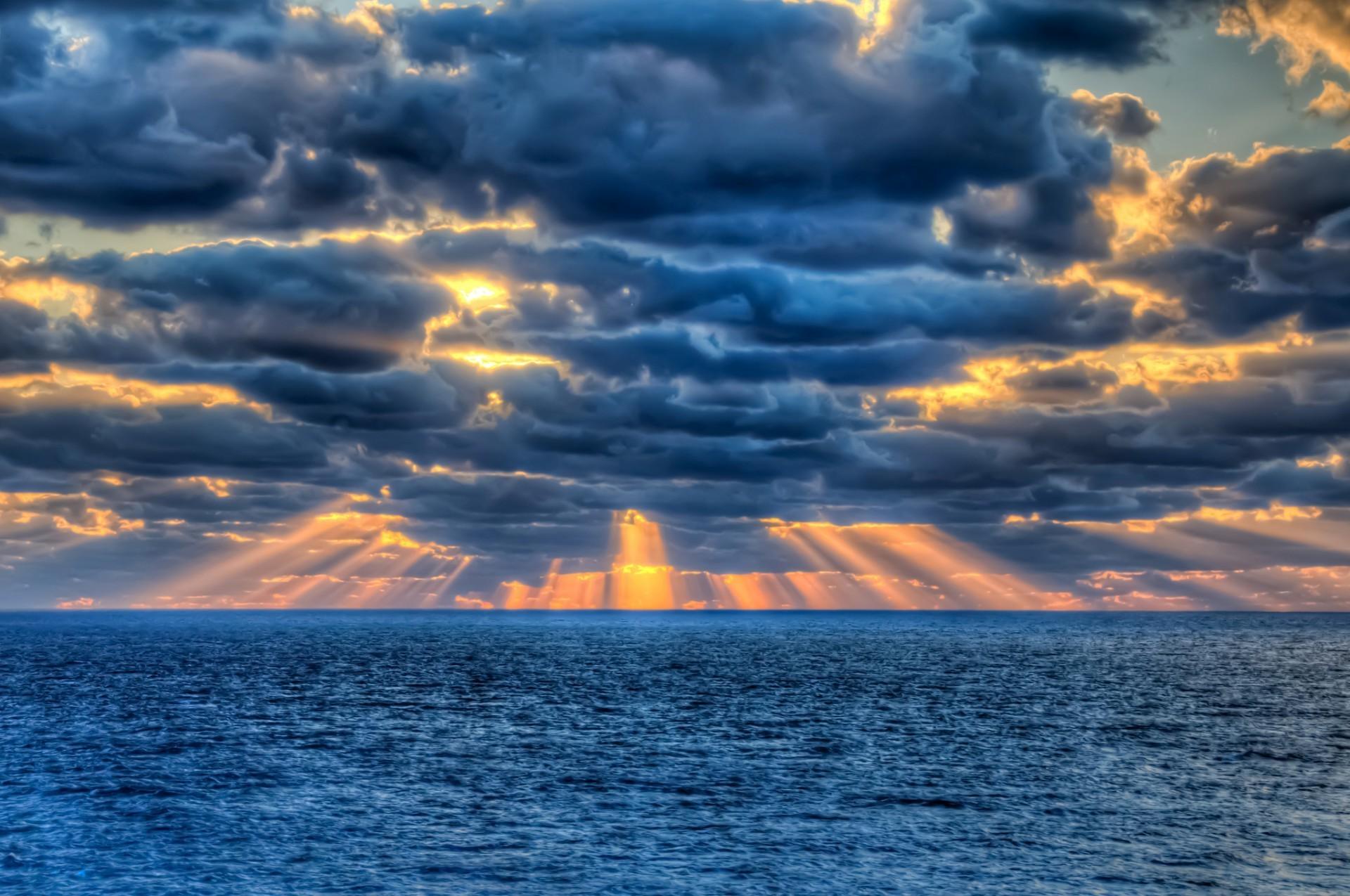 The sun's rays breakinguds over the sea