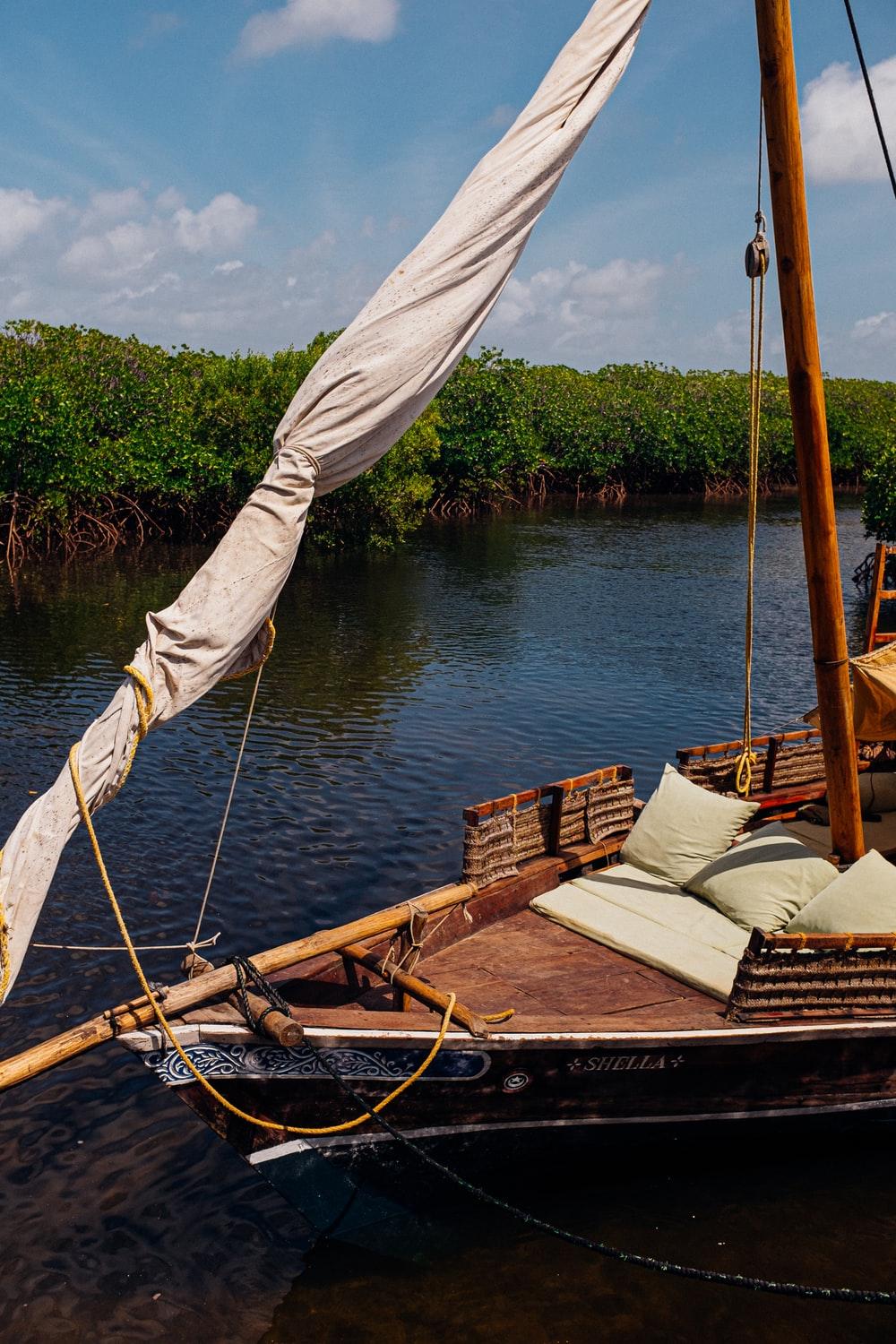 brown boat with white sails photo