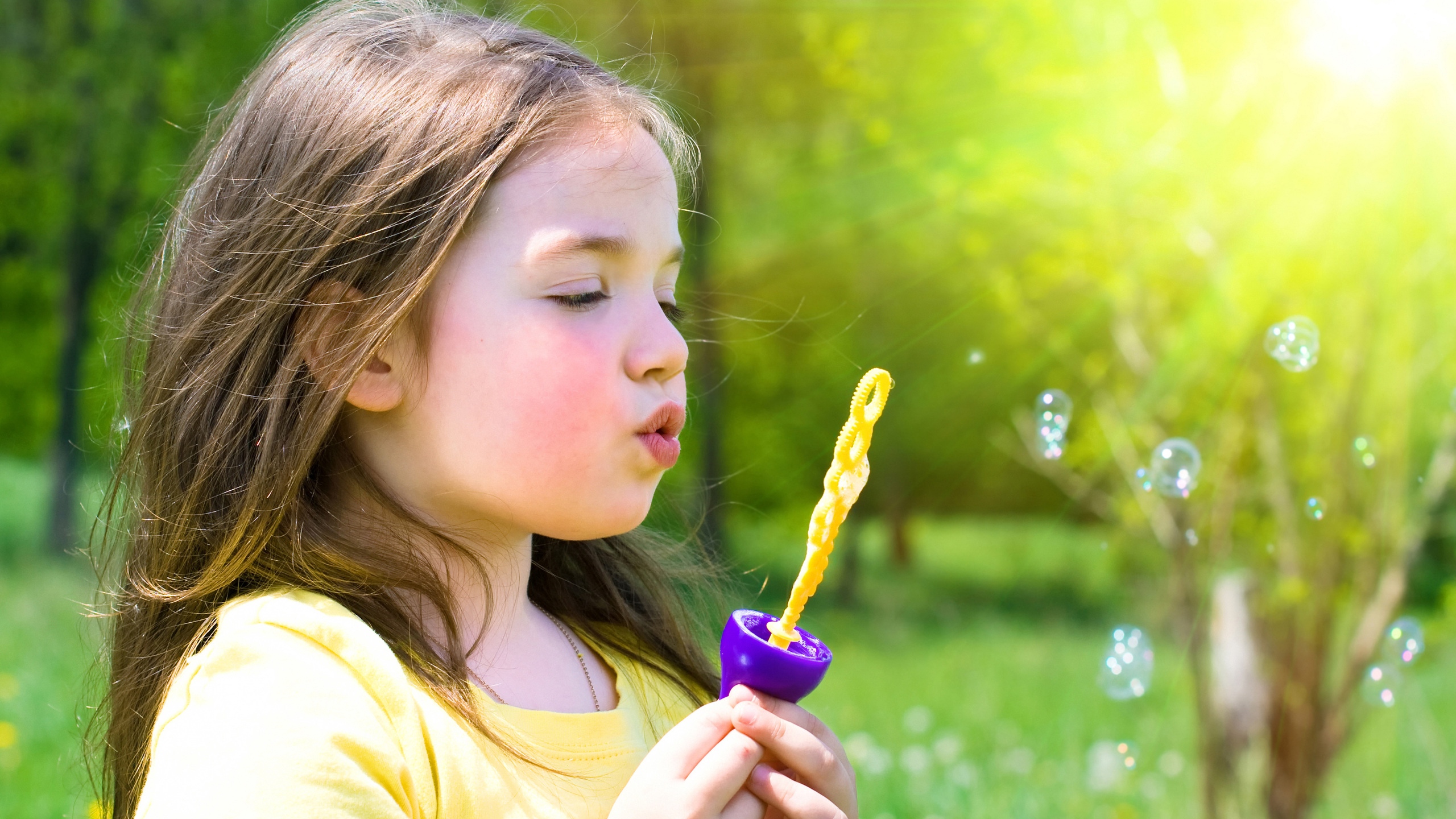 Download wallpaper 2560x1440 child, girl, bubbles, grass, hobby