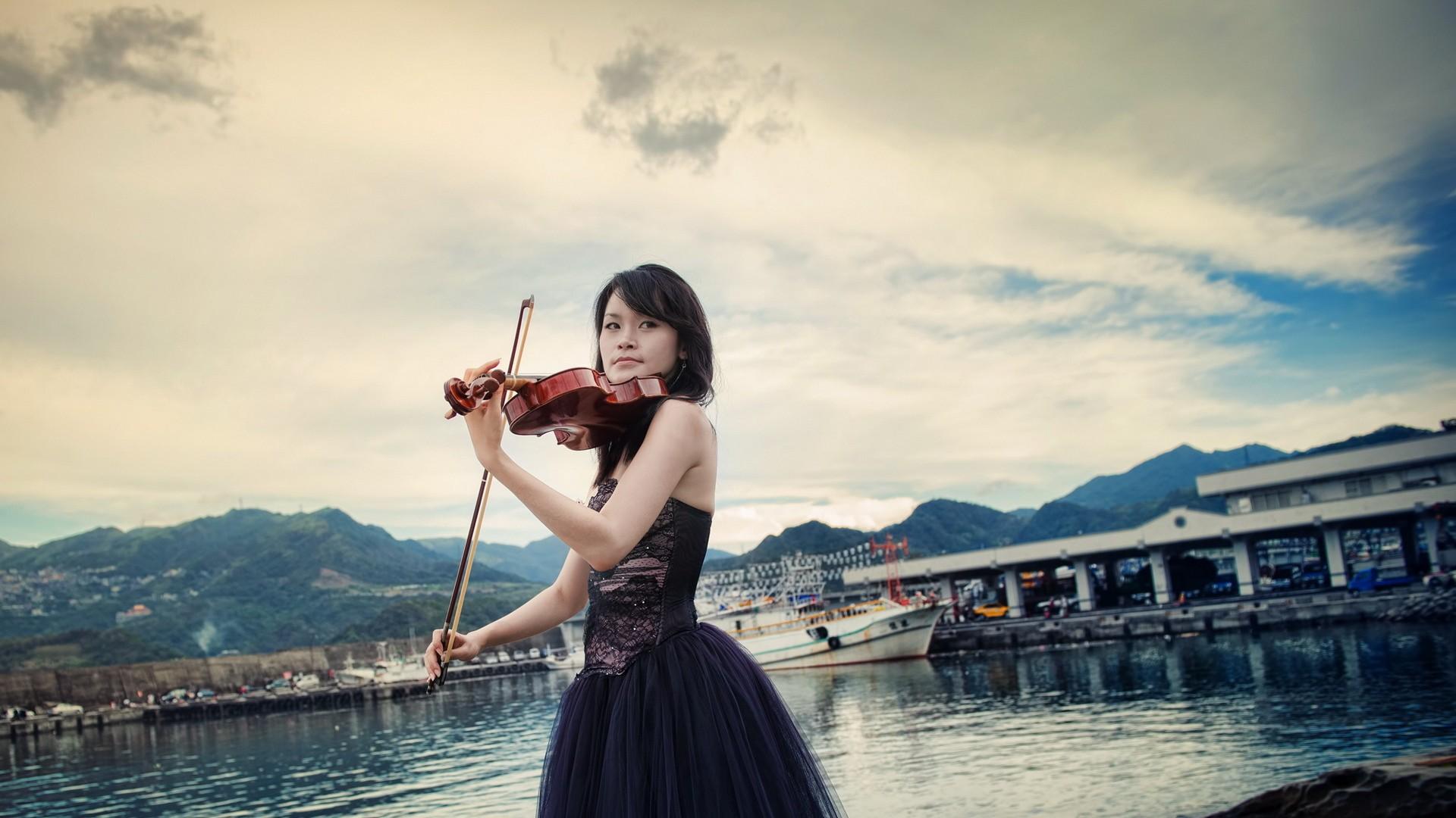 Girl with a violin on a background of the ship wallpaper