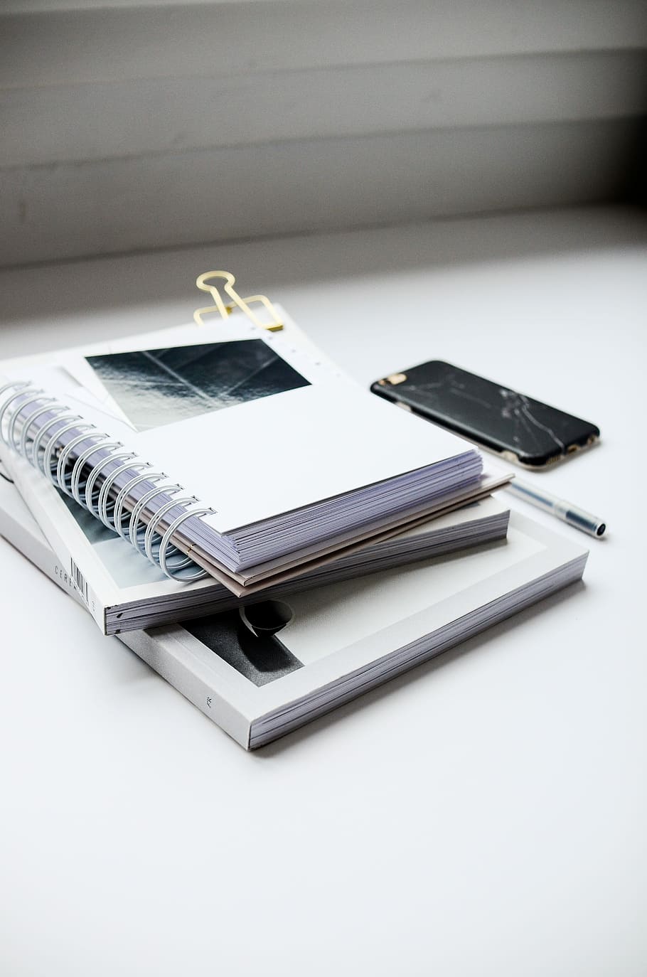HD wallpaper: white spiral notebook beside black smartphone