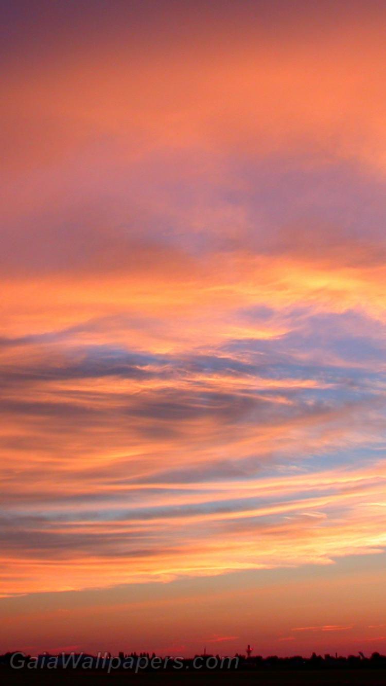 Cloudy sky fading softly into sunset wallpaper 750x1334