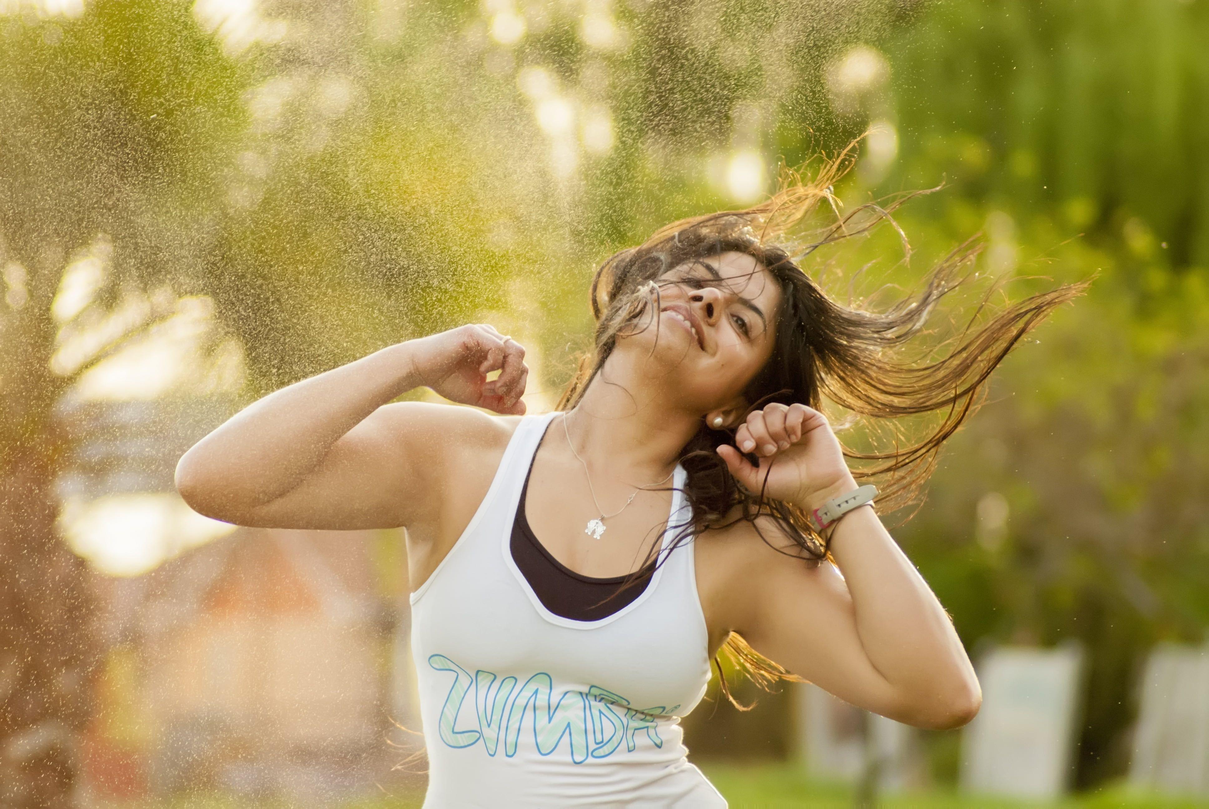 Shallow focus photography of woman in white and blue zumba print