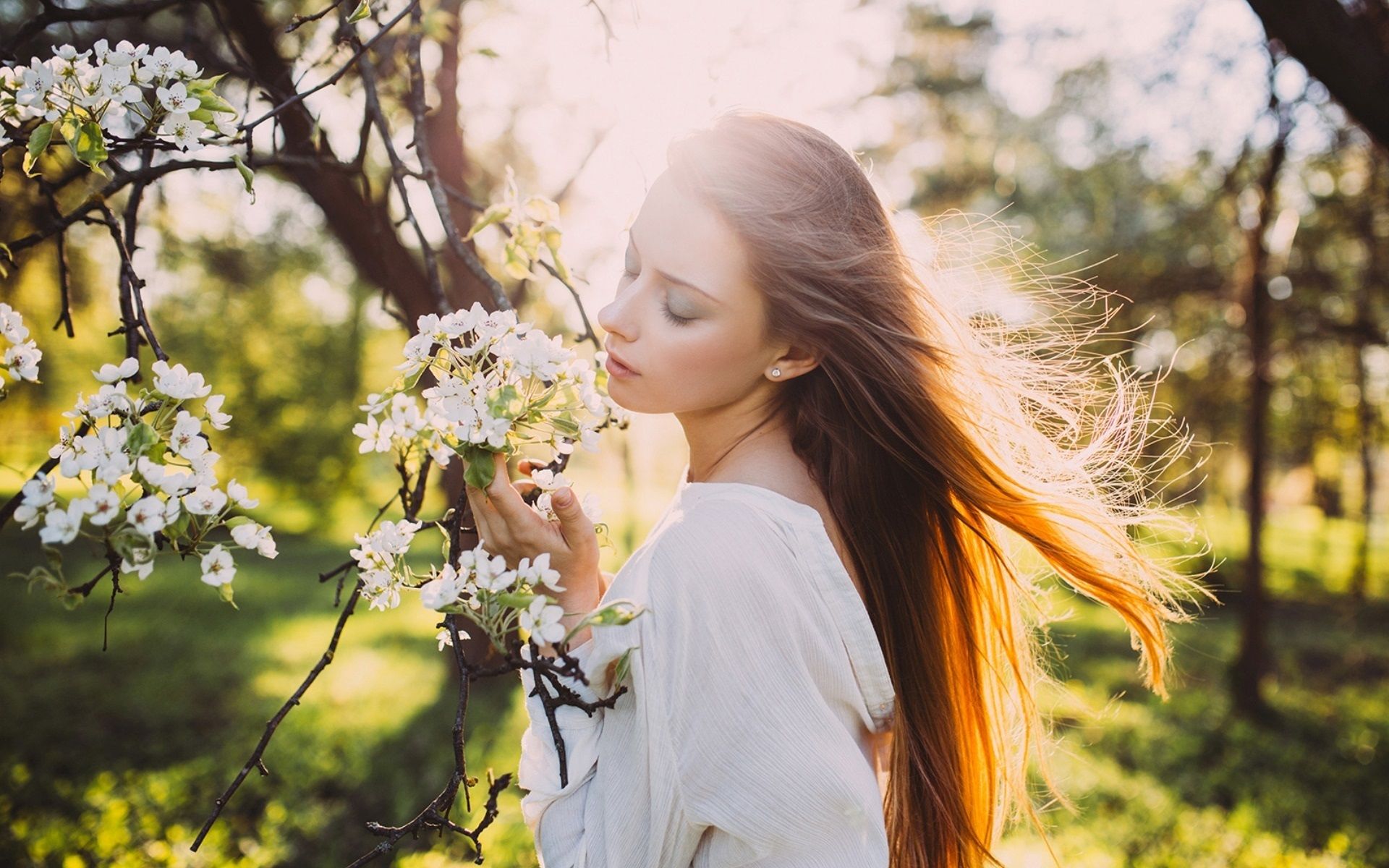Girl hair in the wind, sun rays, spring, white flowers wallpaper