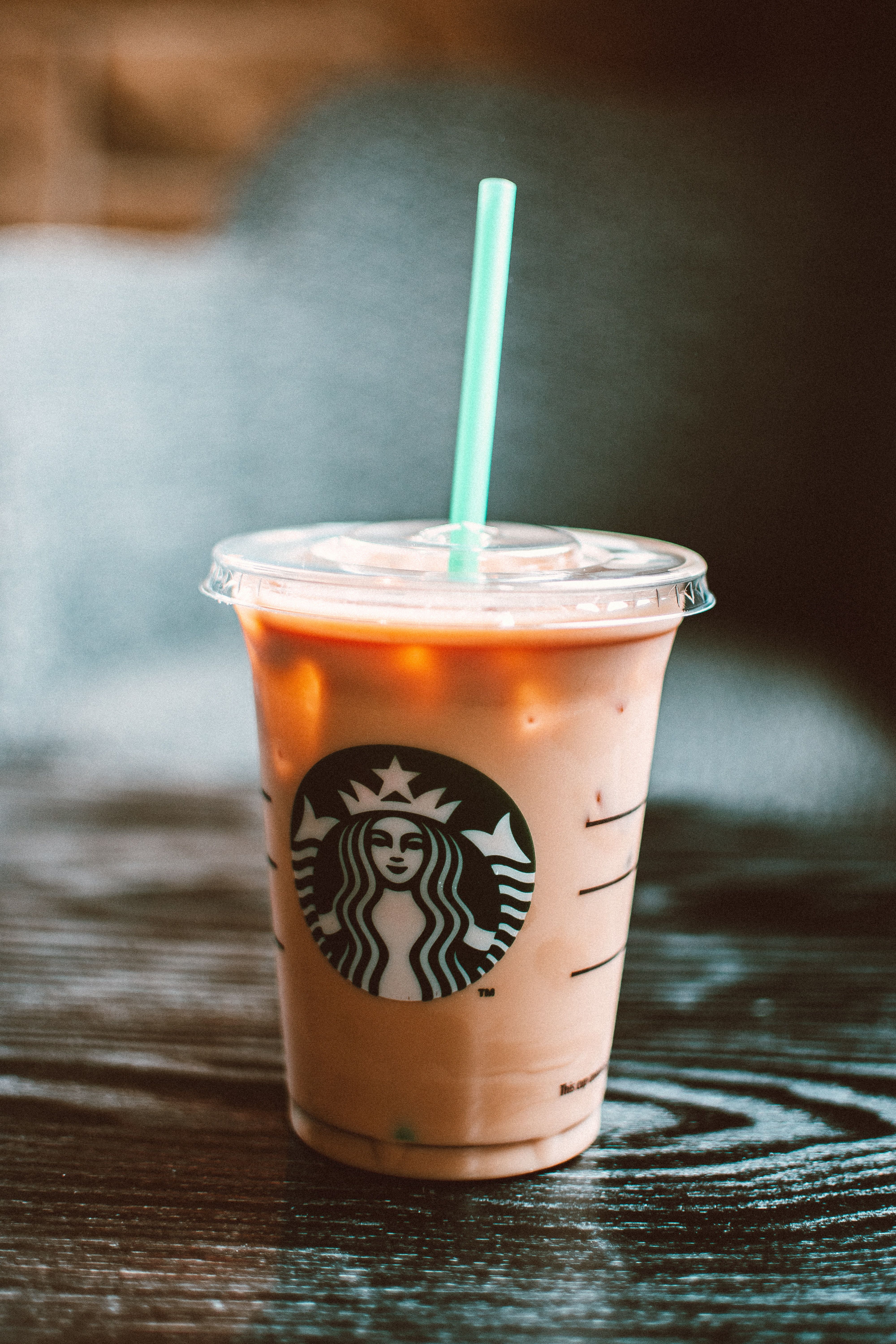 Starbucks Cold Beverage On Table With Straw · Free