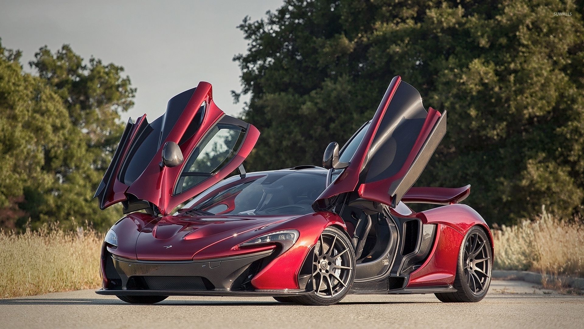 Front side view of a red McLaren P1 .suwalls.com