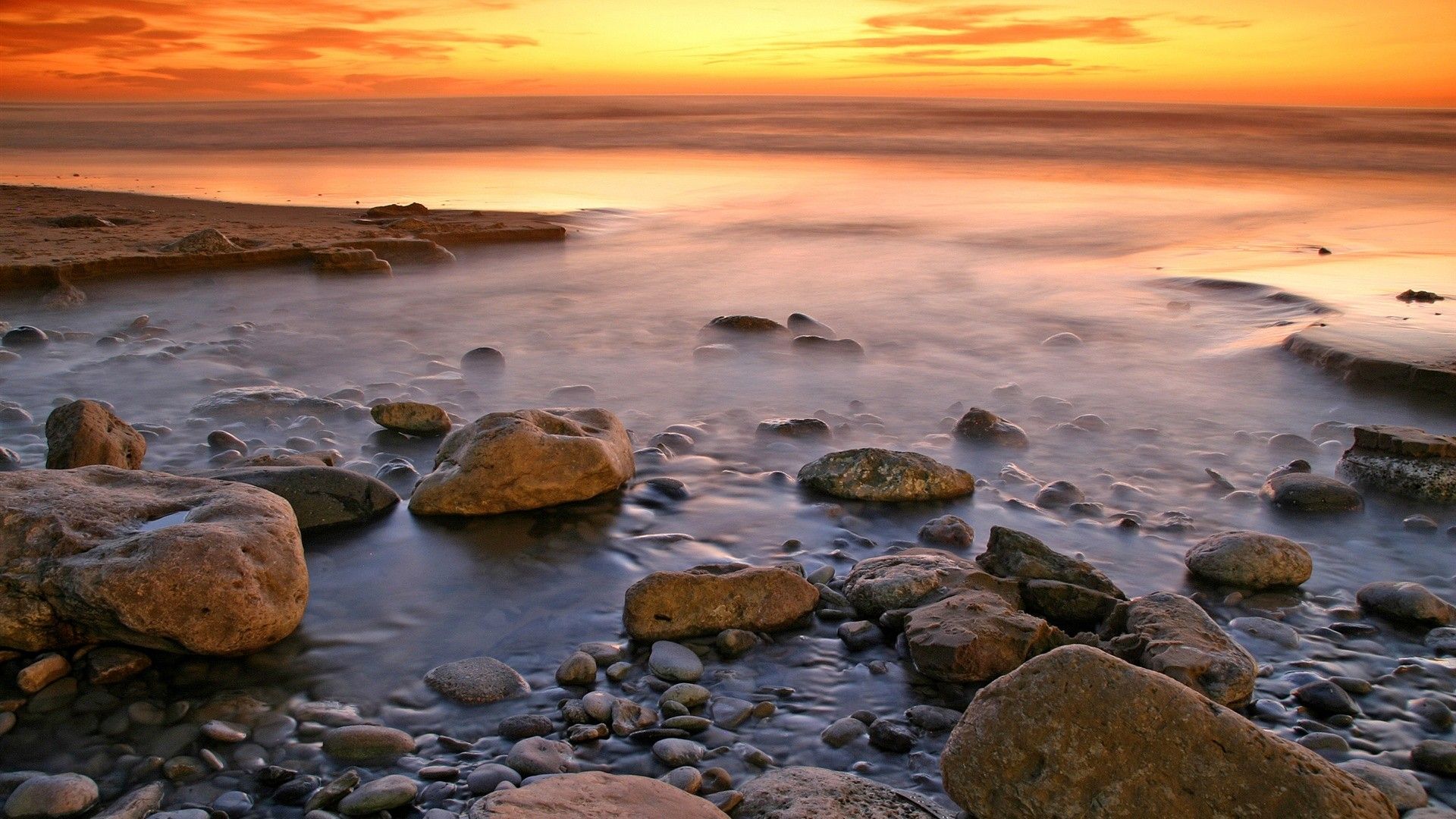 Beach Landscape With Water And Rocks