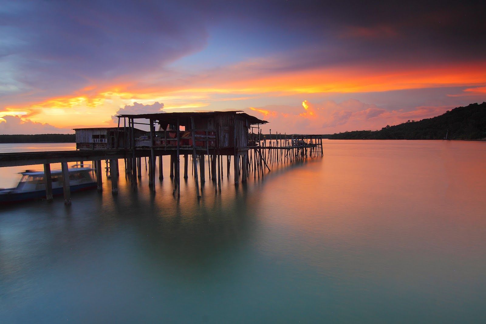 Wooden Cabin On Water And Sunset