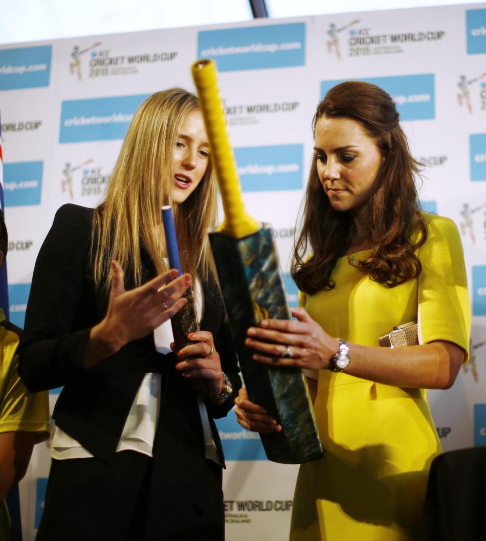 Download Catherine, Duchess of Cambridge (R) is presented with a