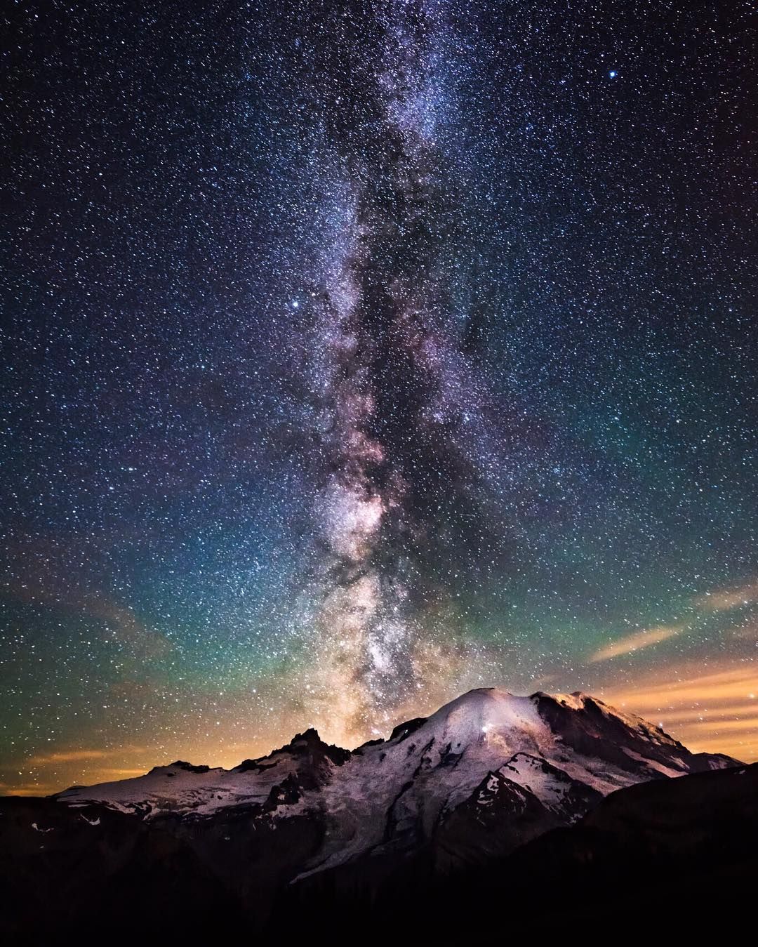 Millions of stars erupt in the night sky over Mount Rainier