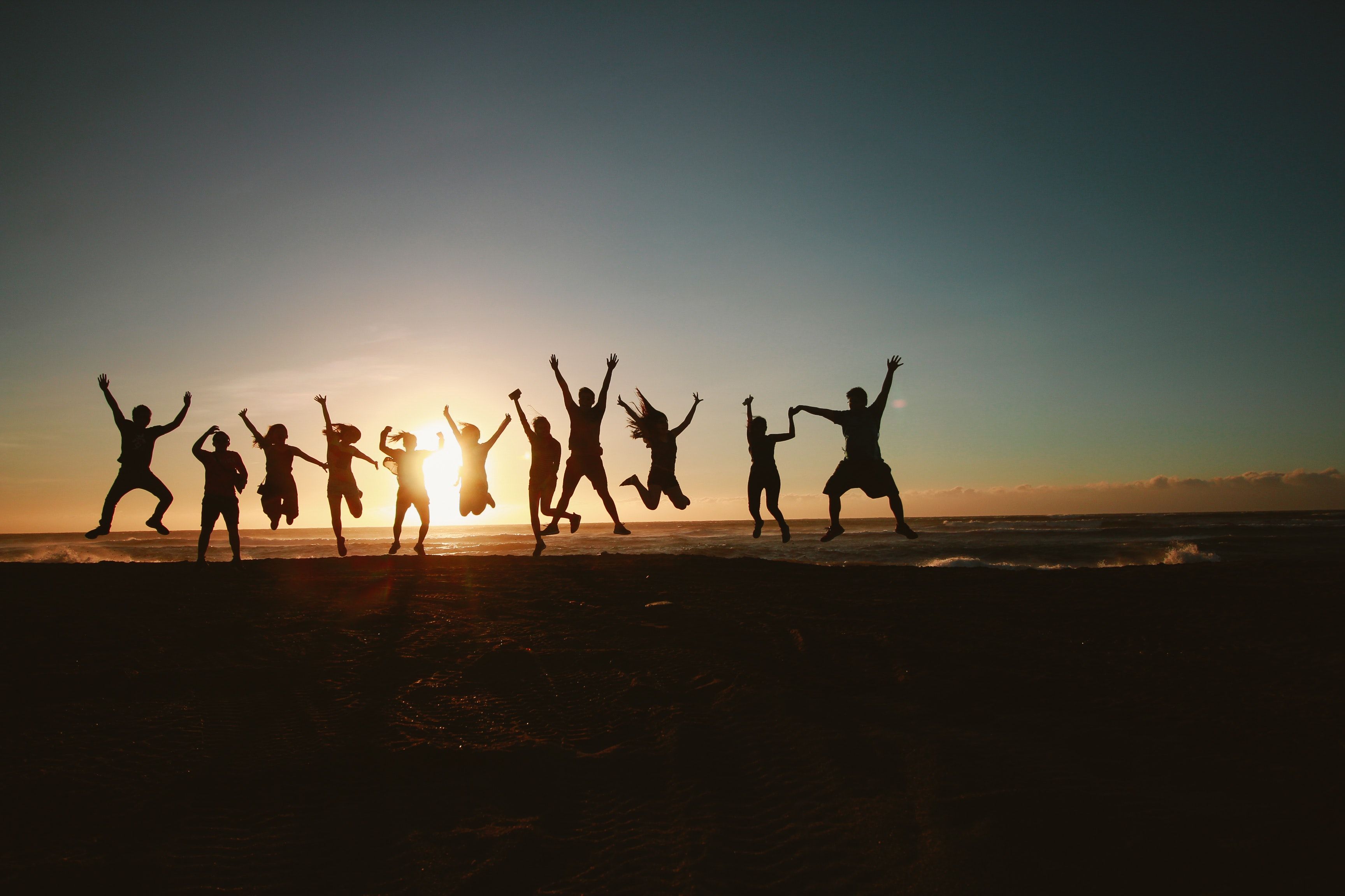 Silhouette Photography of Group of People Jumping during Golden
