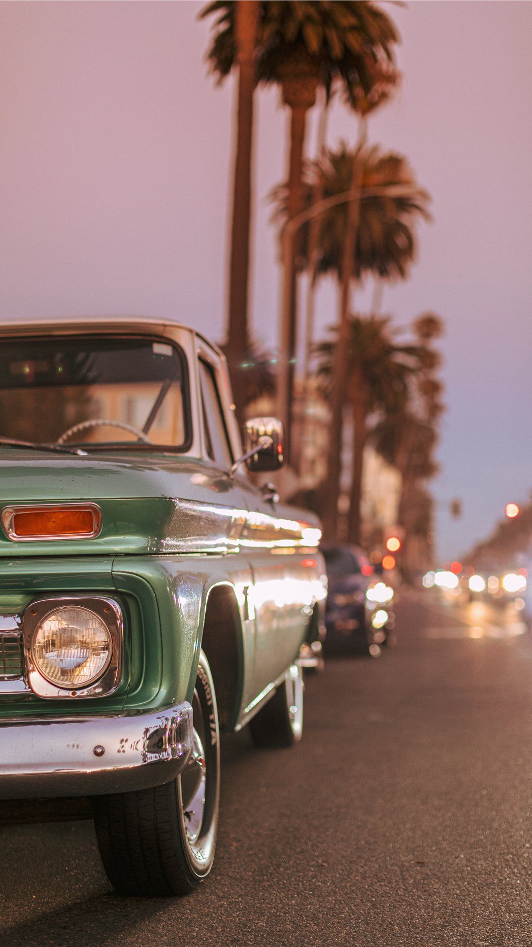 Vintage car parked on Ocean Blvd during sunset iPhone 8 Wallpaper
