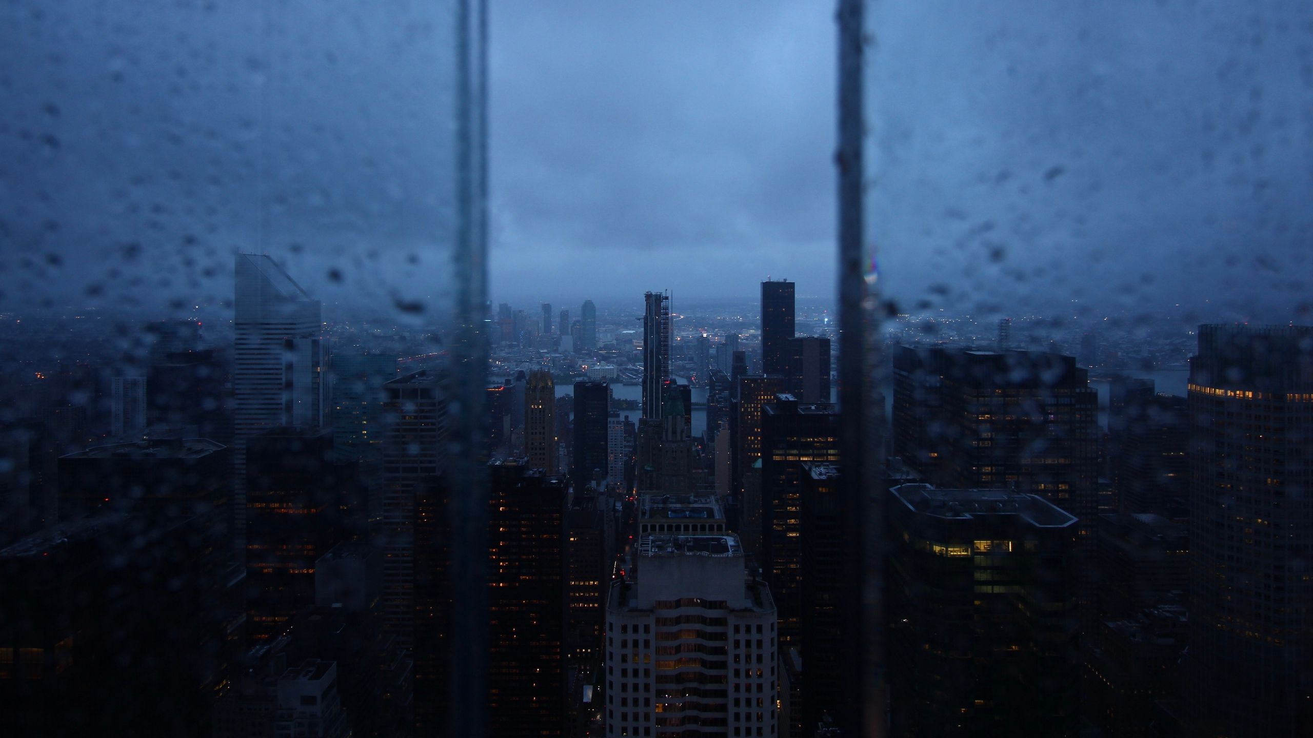 Download wallpaper 2560x1440 night city, window, rain, skyscrapers
