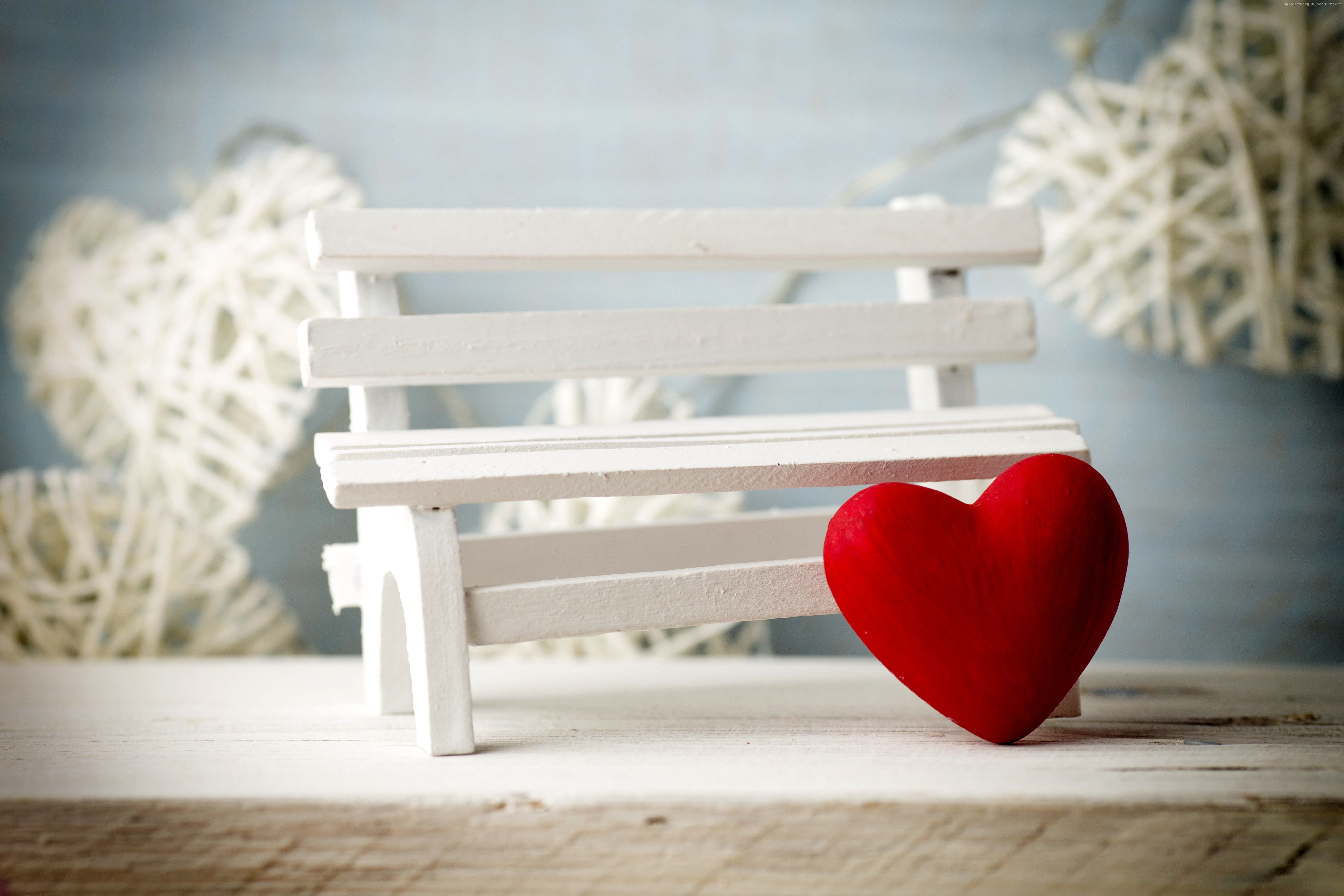 Red heart decor beside white bench miniature photography HD