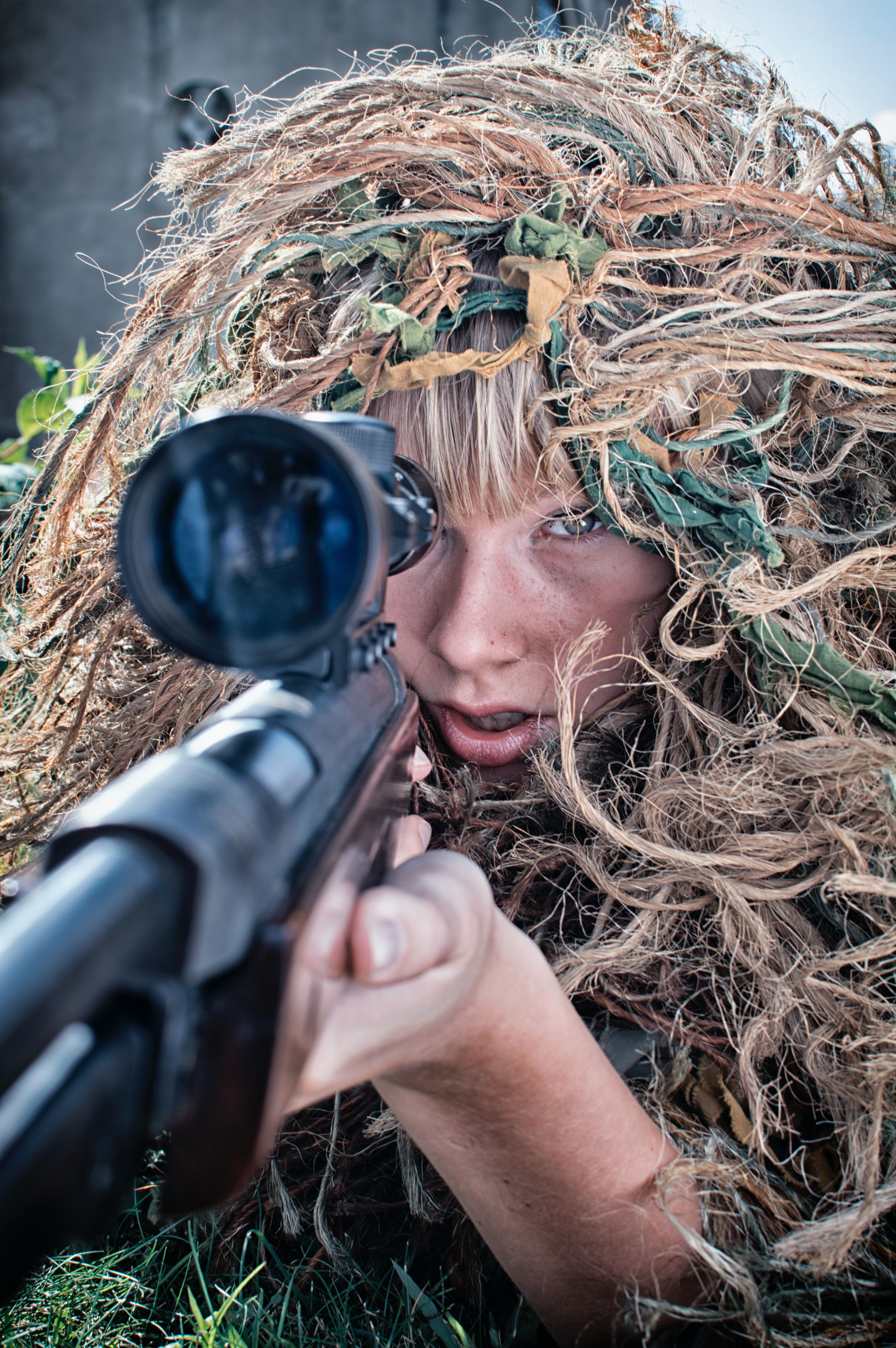 woman wearing gillie suit holding sniper rifle photo