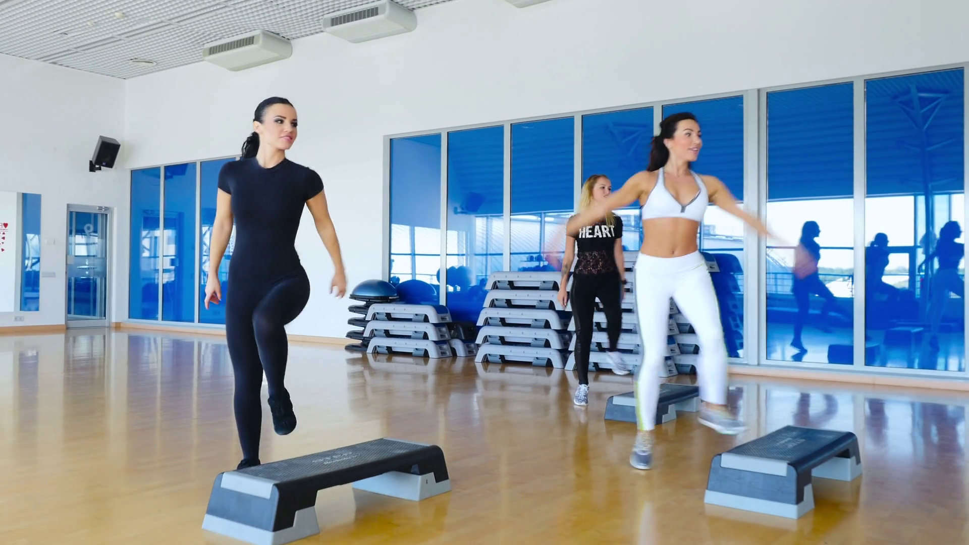 Young sporty women training the step aerobics in the gym Stock