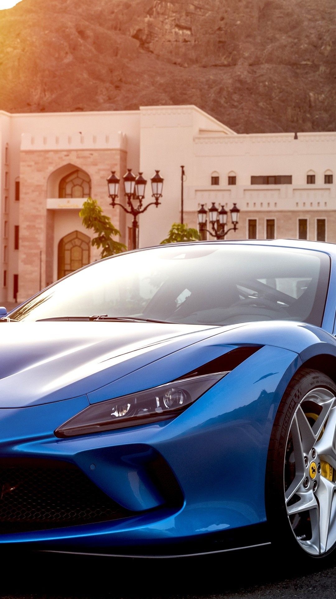Download 1080x1920 Ferrari F8 Tributo, Blue, Sunlight, Front View