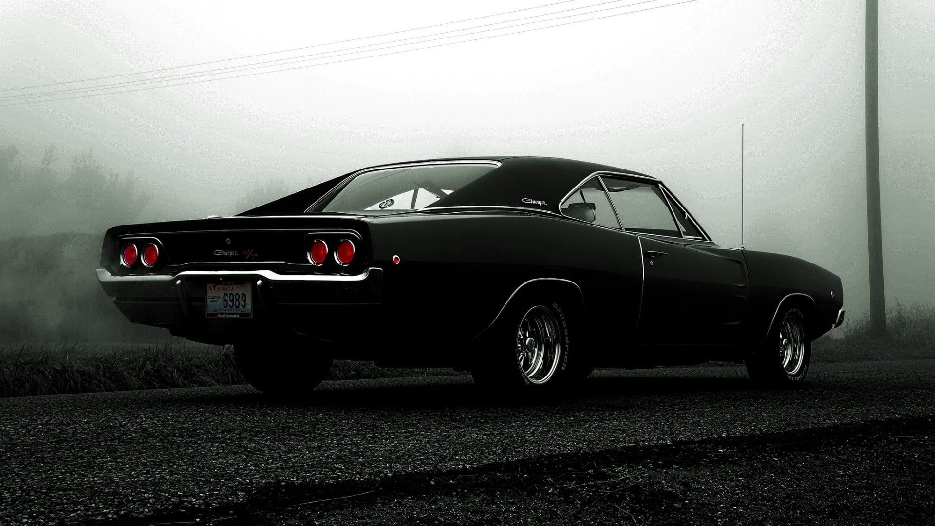Classic black Dodge Challenger coupe on asphalt road HD wallpaper