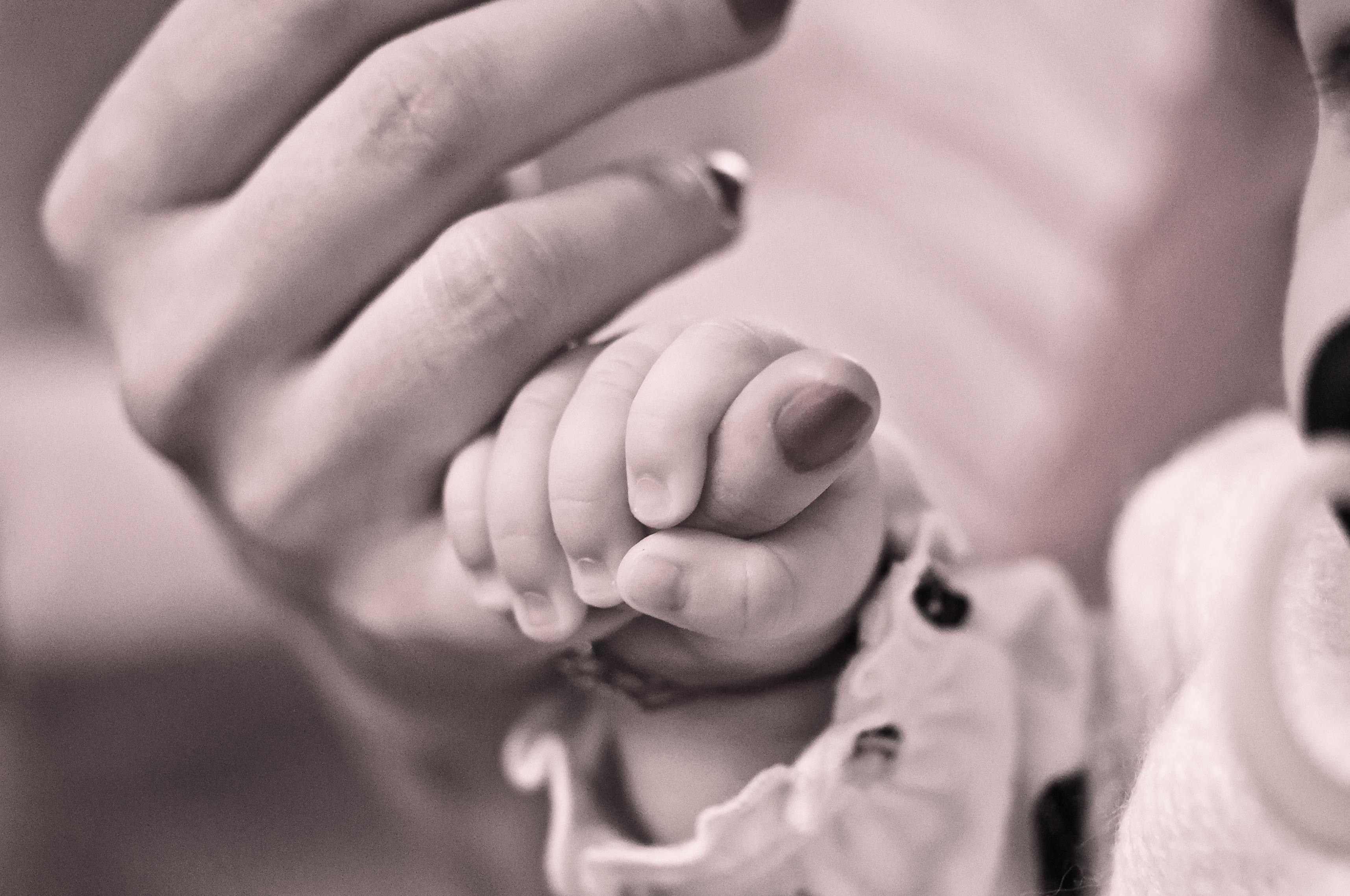 grayscale of baby holding hands with her mother free image